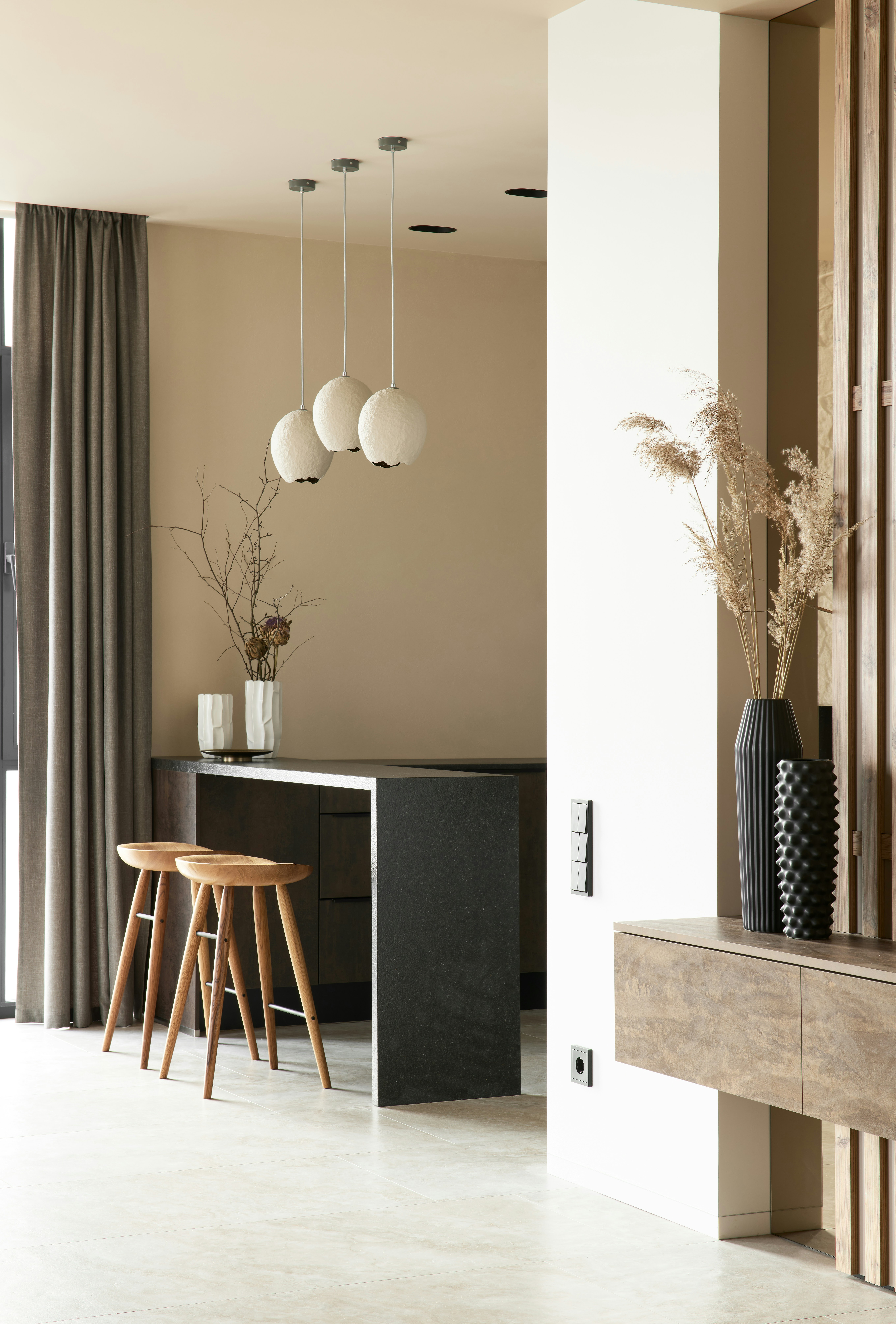 A modern kitchen with light wood countertops and island.