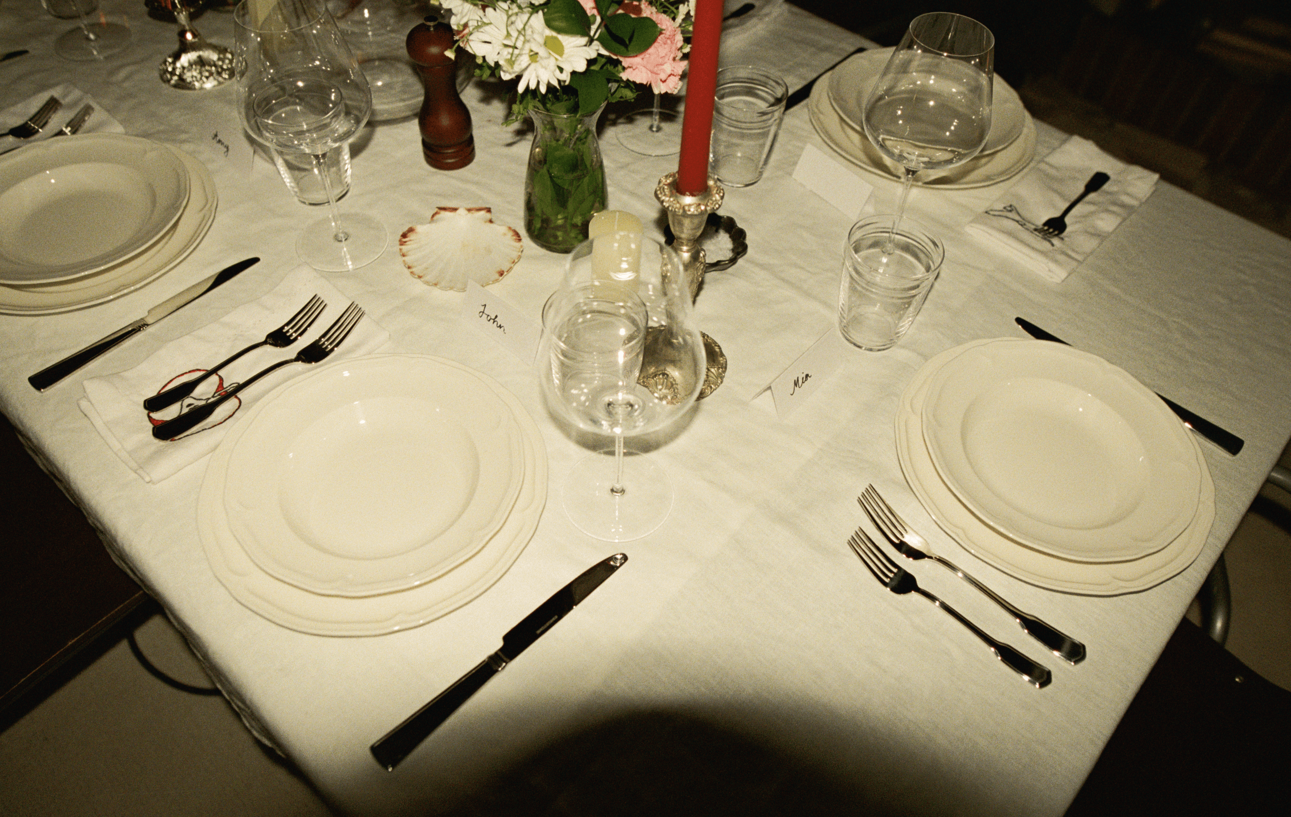 A decorative floral arrangement spills over a table draped in red fabric, creating an elegant atmosphere.