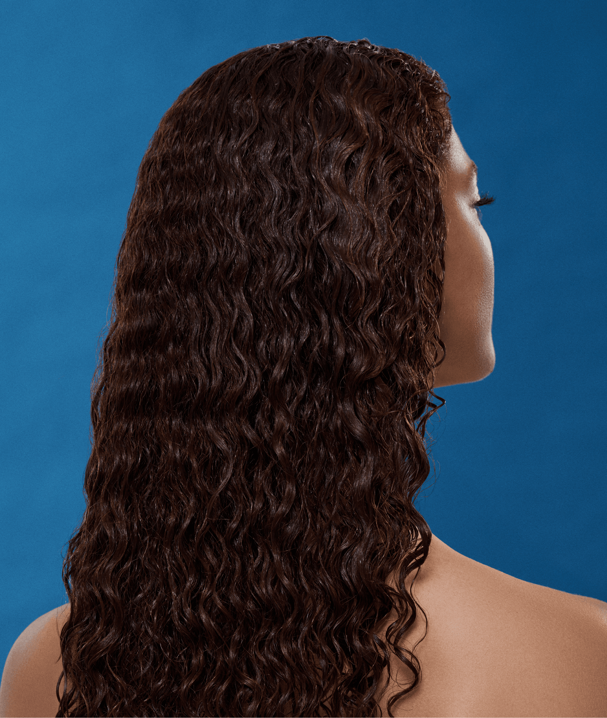 Campaign portrait of model with voluminous curly hair for Grow-Good Beauty art direction
