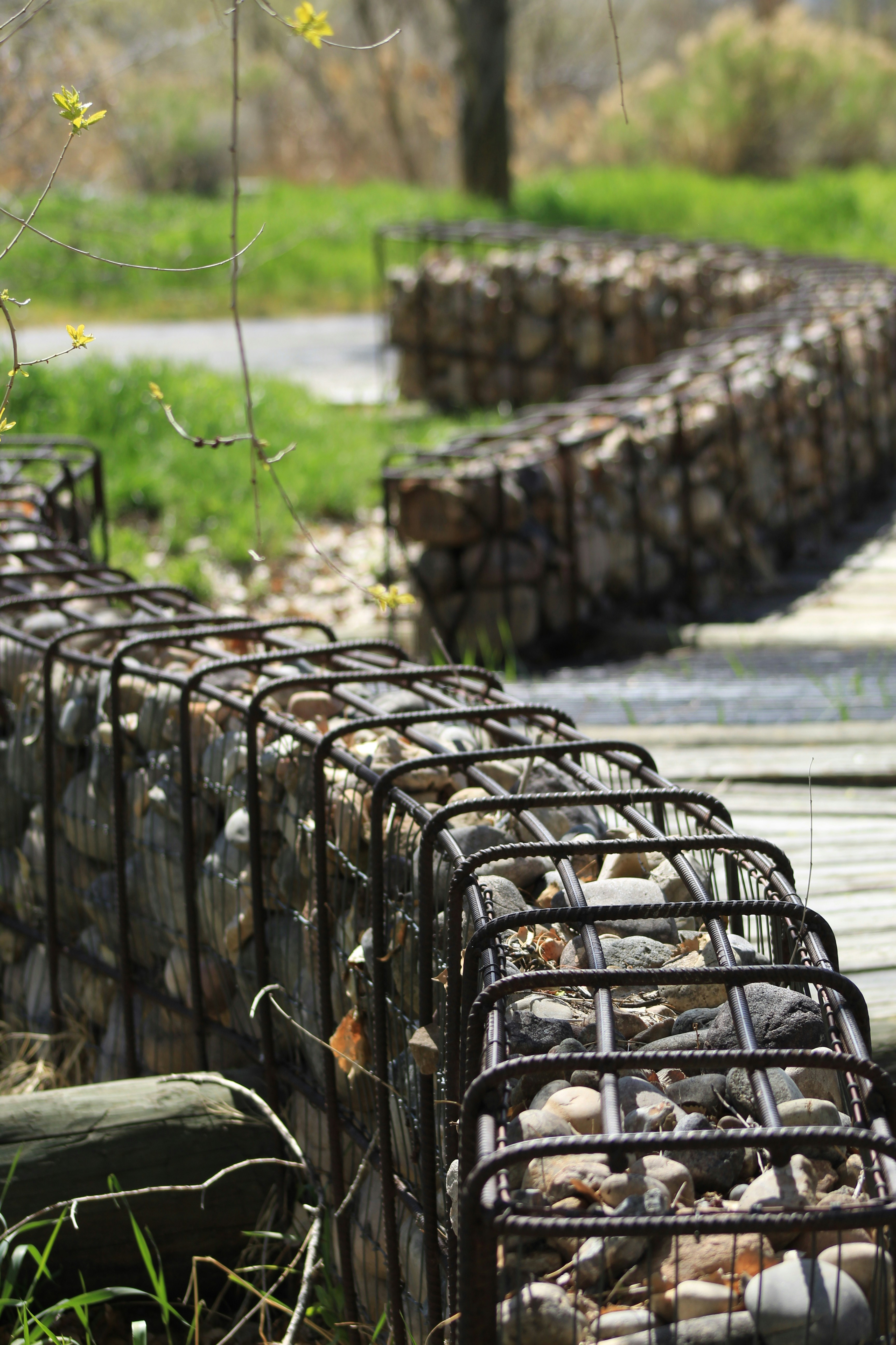 black metal fence on green grass field during daytime