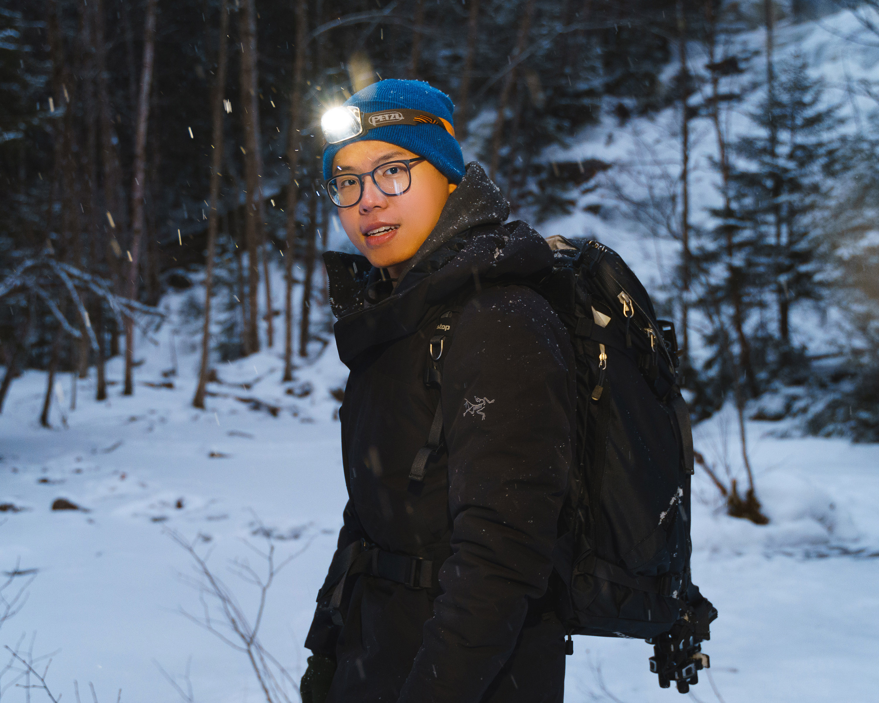 Portrait of a man in backpacking in a snowy landscape