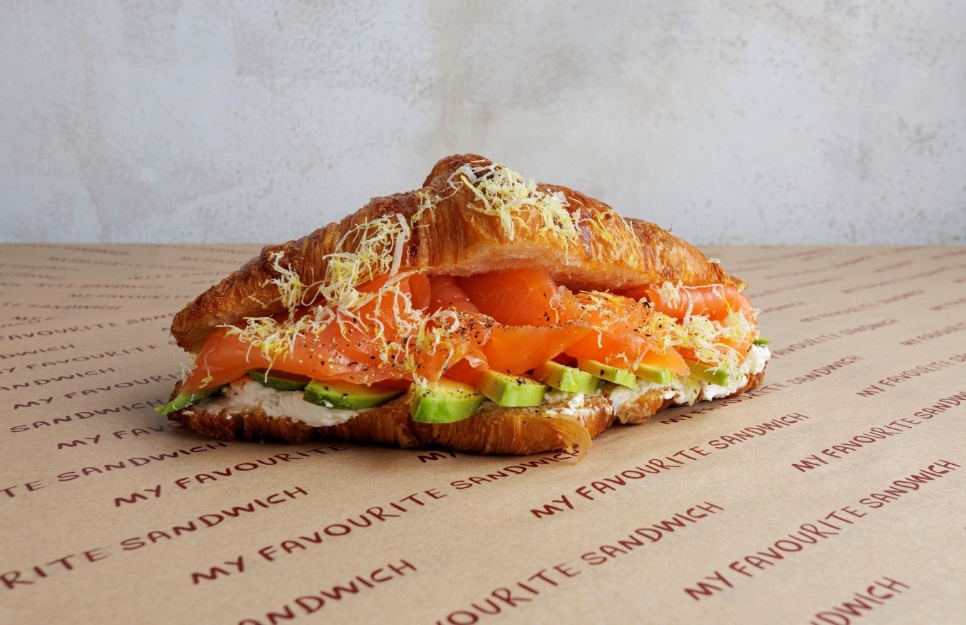 Toasted butter croissant, with smoked salmon, avocado, lemon zest, dill & chive cream cheese