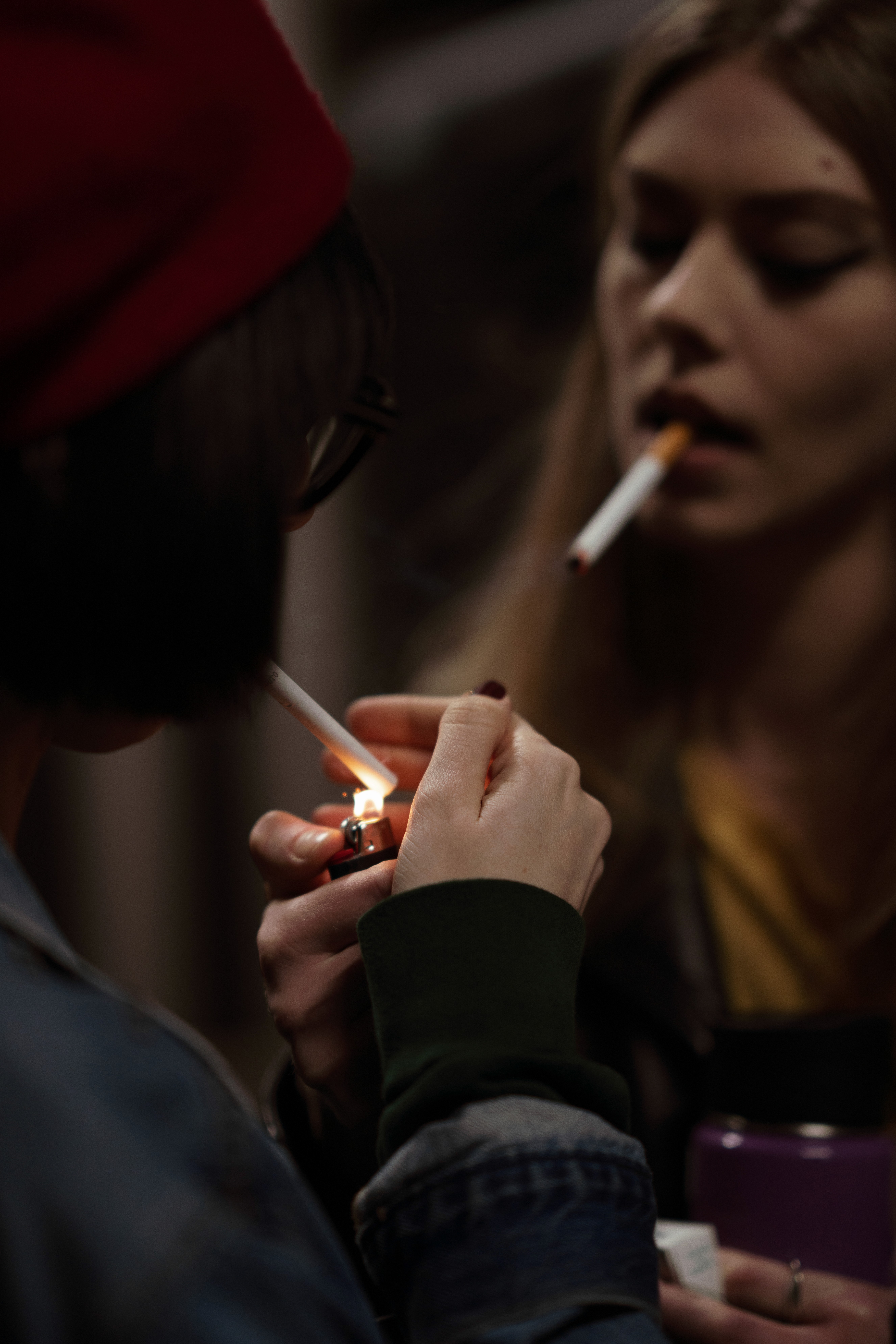 Models light cigarette outside Marc Jacobs show