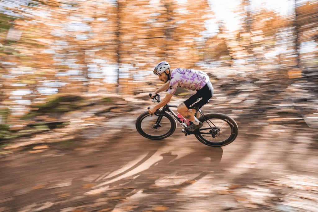 Cyclist riding through a forested landscape