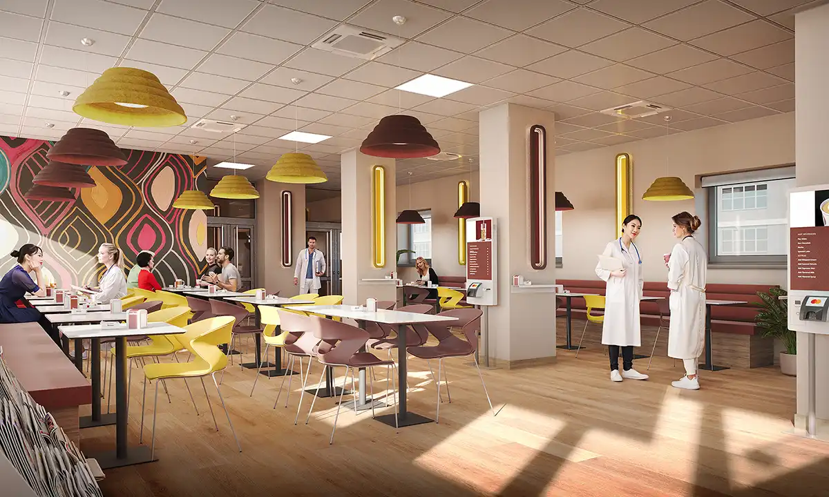 Spacious modern cafeteria with colorful yellow and pink chairs, digital menu board, and staff in white coats. Interior design for hospital or corporate lounge.