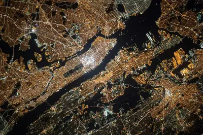 Una vista notturna di una città con luci brillanti e corsi d'acqua scuri