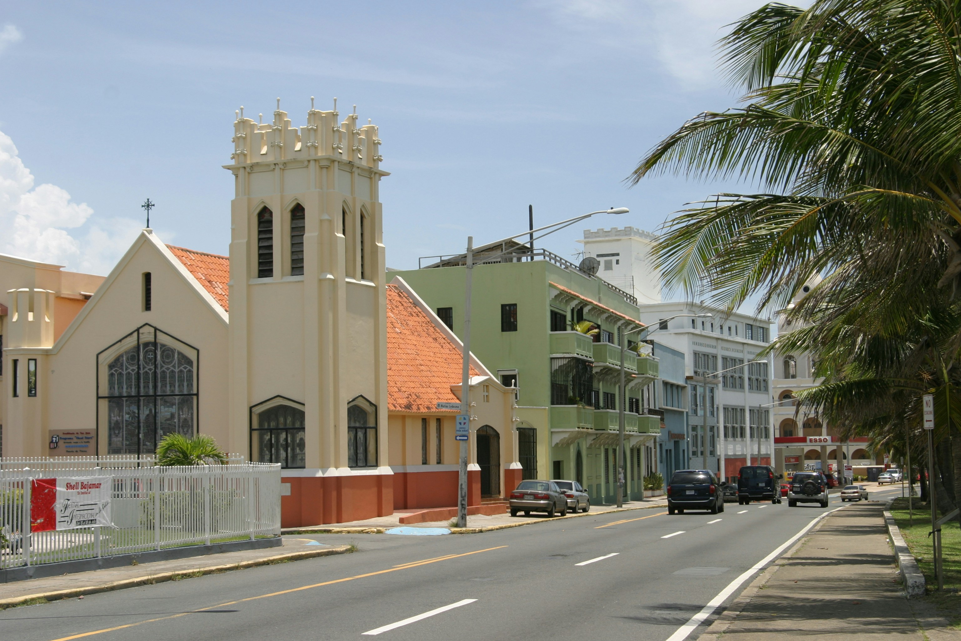 a street lined with buildings and palm trees