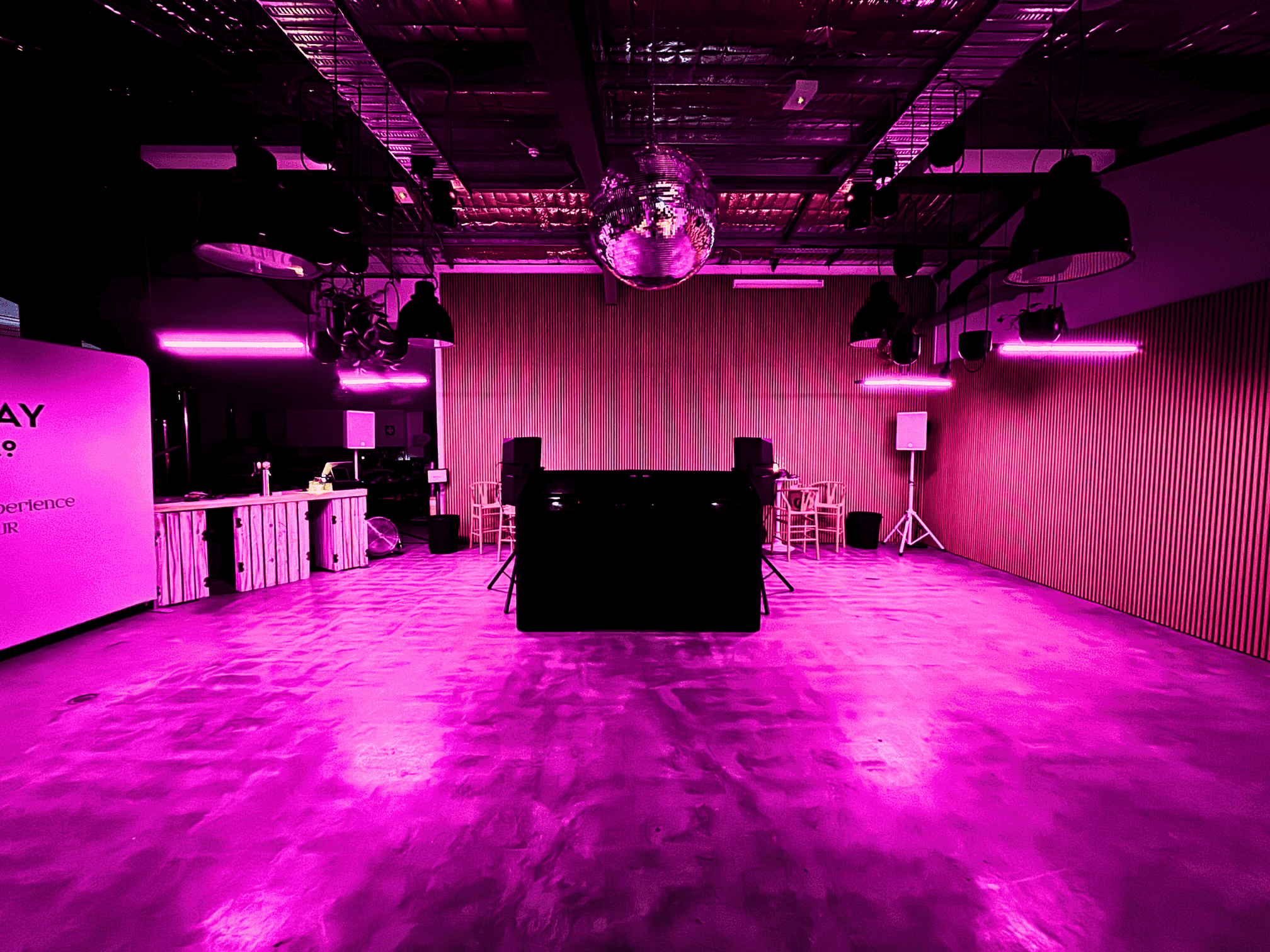 gray concrete pathway in between of brown wooden walls