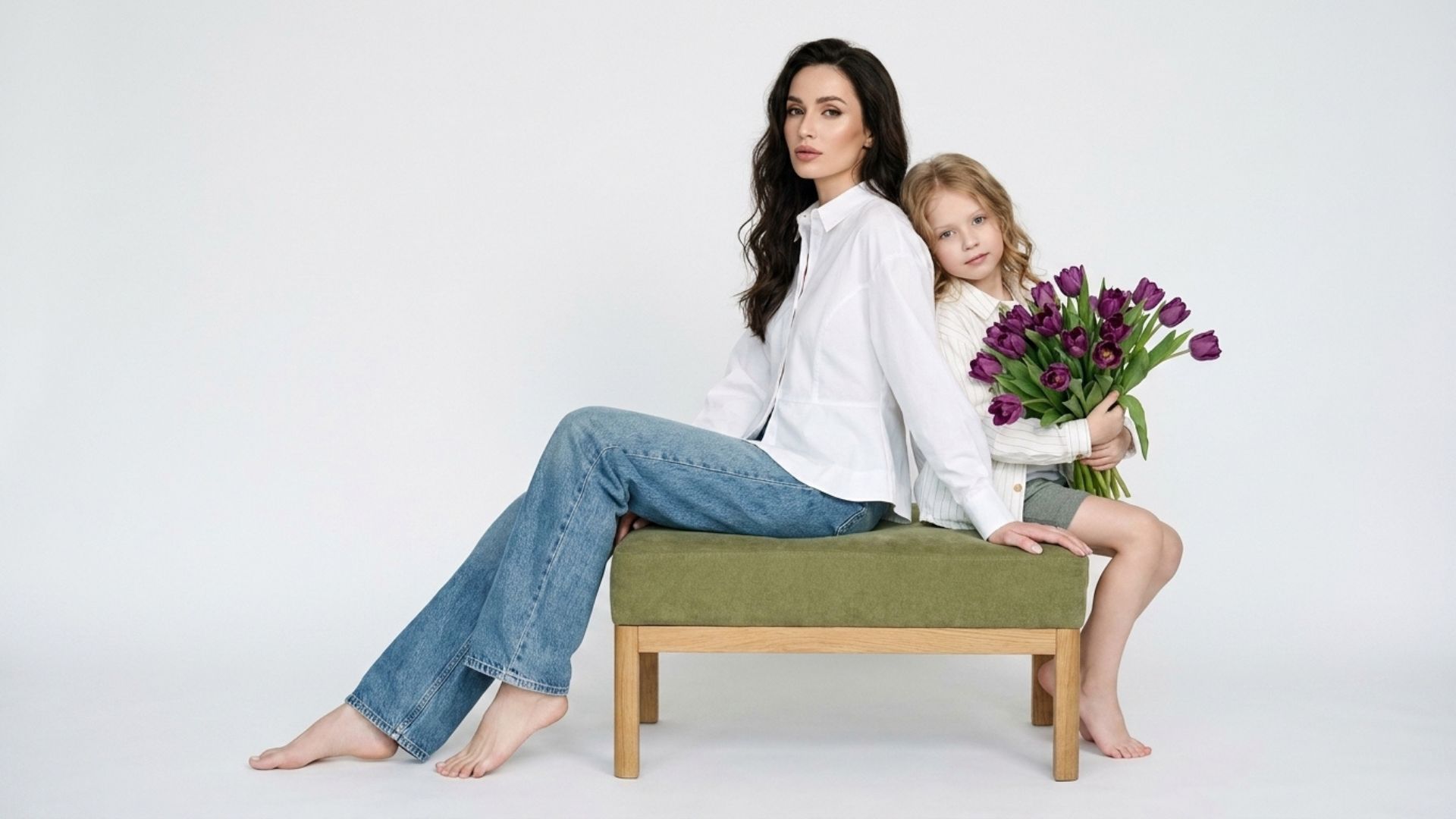 mother and daughter studio image posnig with flowers