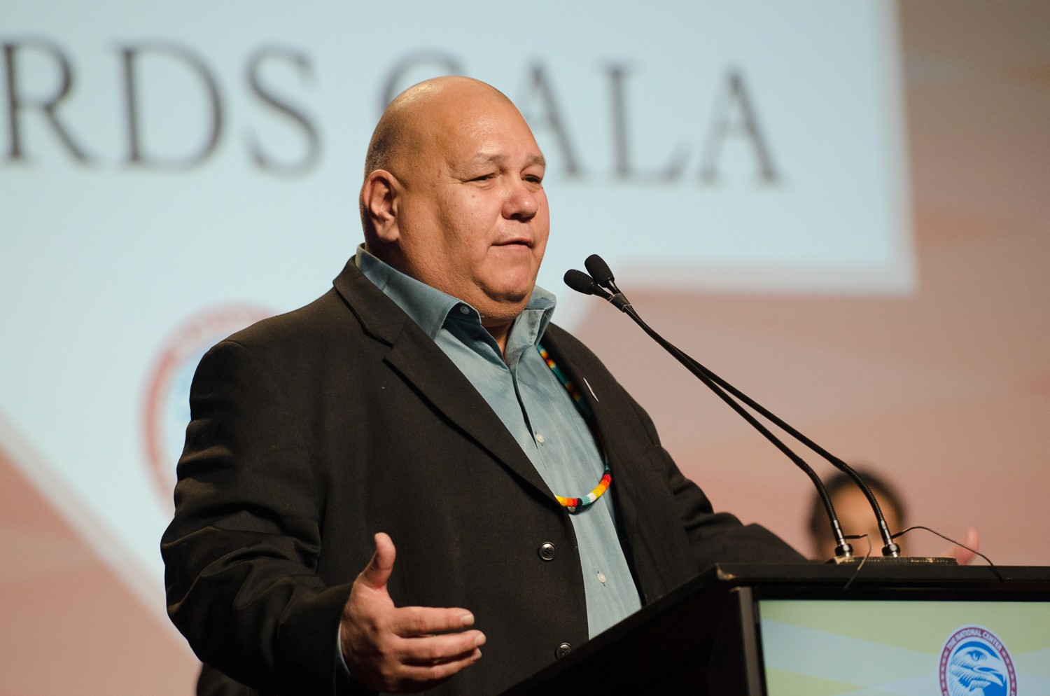 group of women in red and white dress standing on brown wooden bar during daytime