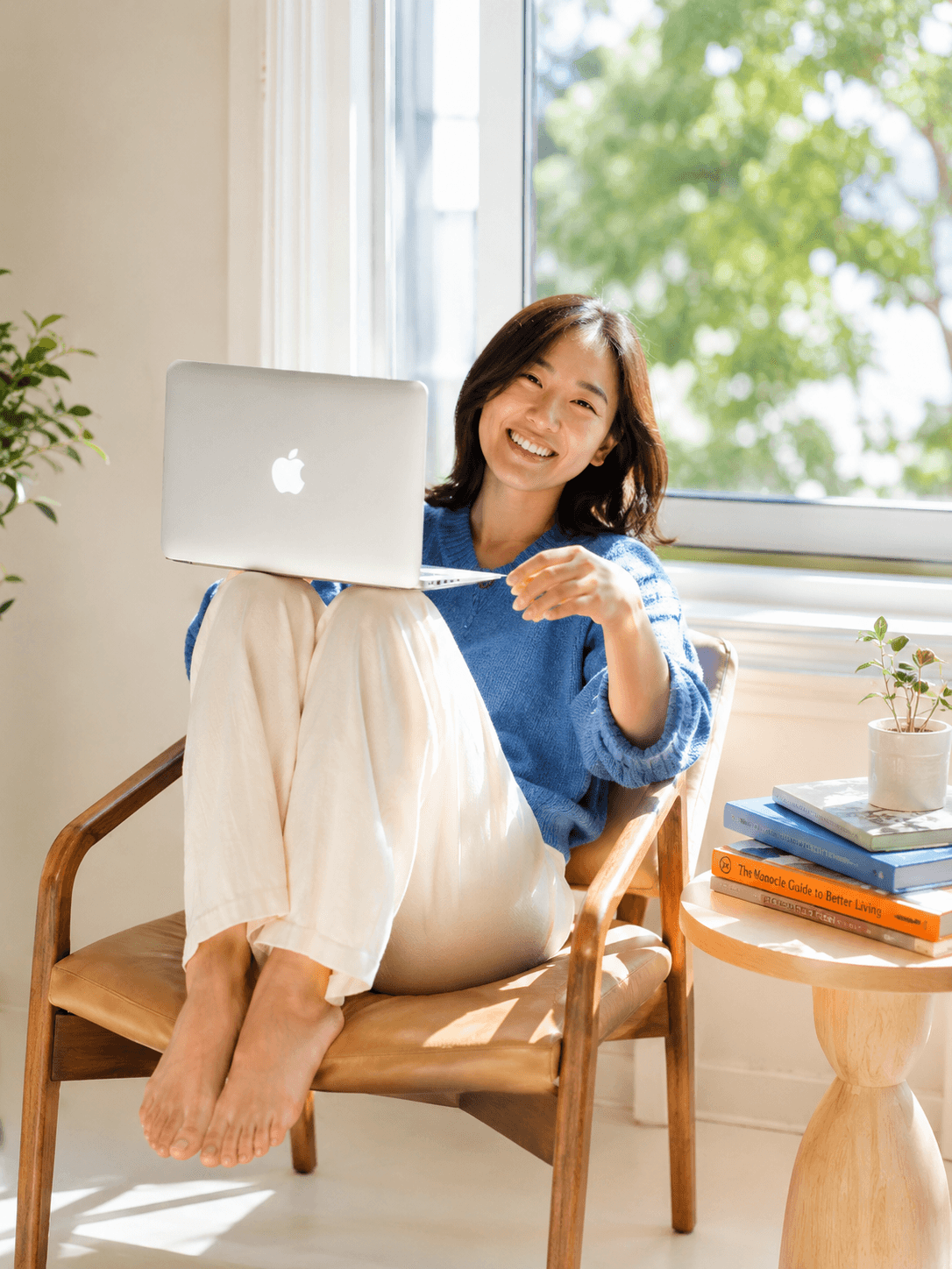 Smiling business owner at a laptop; illustrative stock photo
