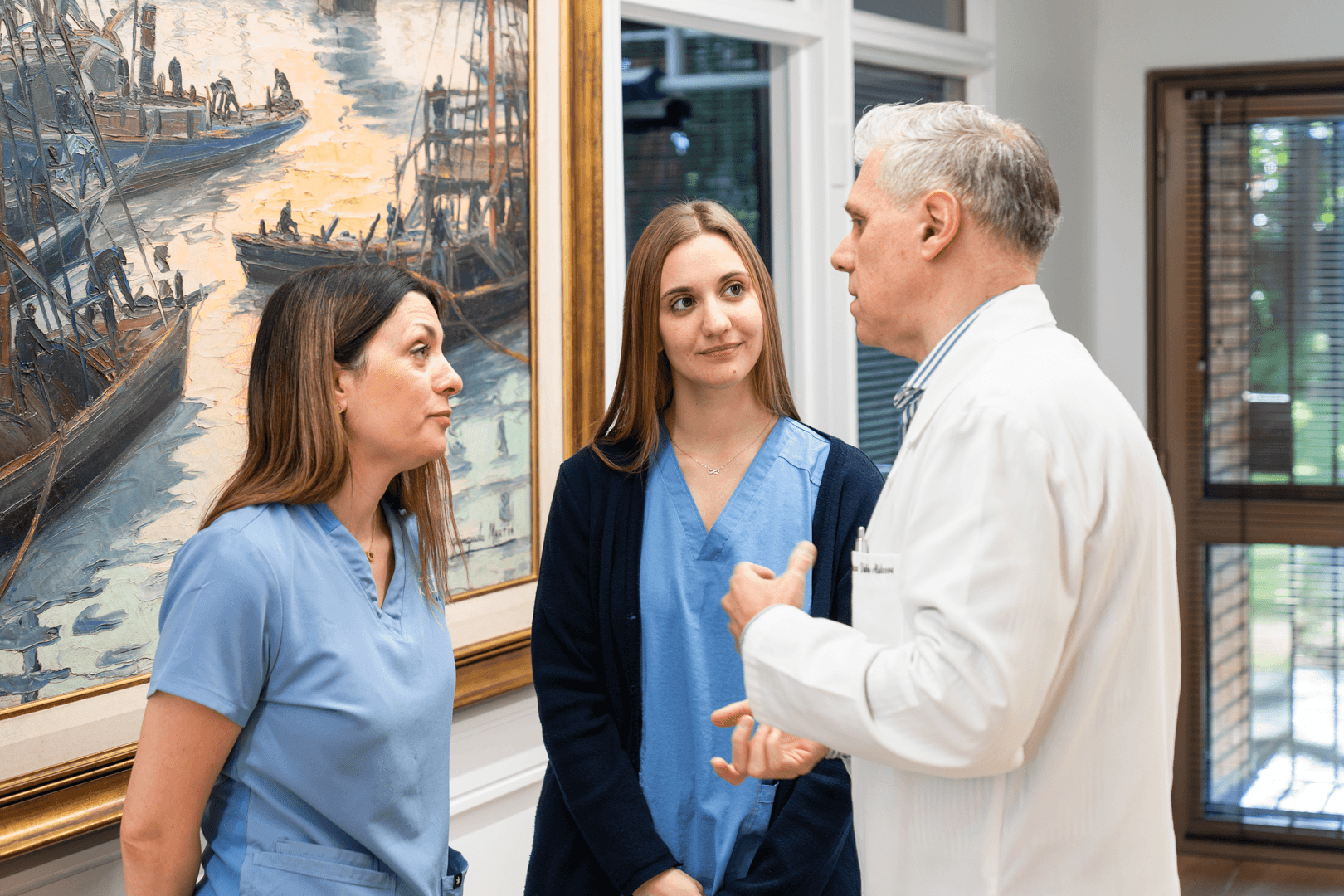 A man stading with Surfboard