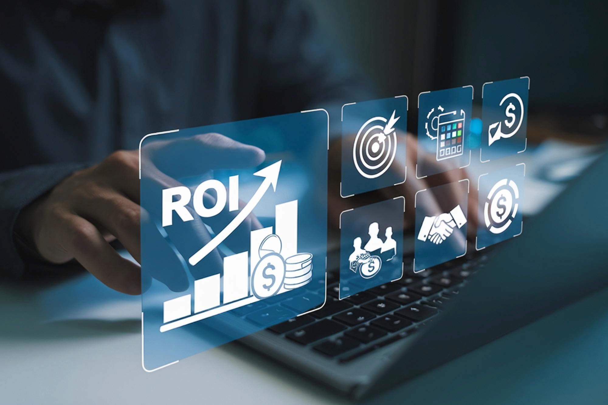 A talent recruiter with a soft smile working on her laptop in the office. The angle is on her face so we can't see what's is on the screen. She is wearing a blazer 