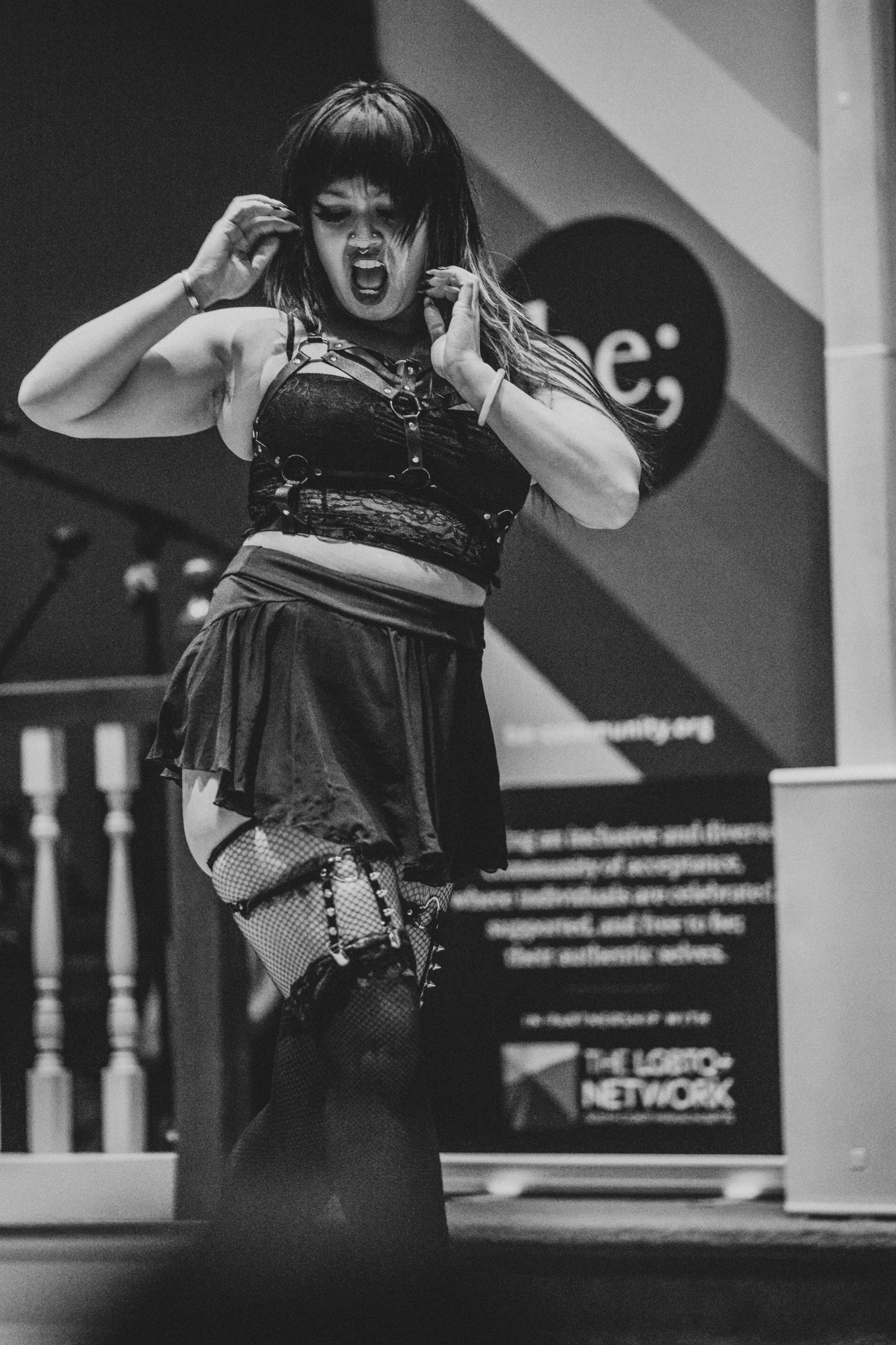 Performer expressing intense emotion during a dance performance at Queer Open Mic hosted by be; community in Bridgewater, Massachusetts