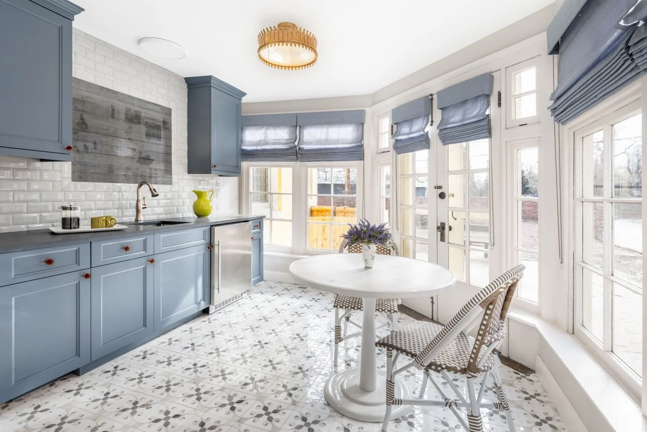 Blue kitchen with breakfast nook and French doors.
