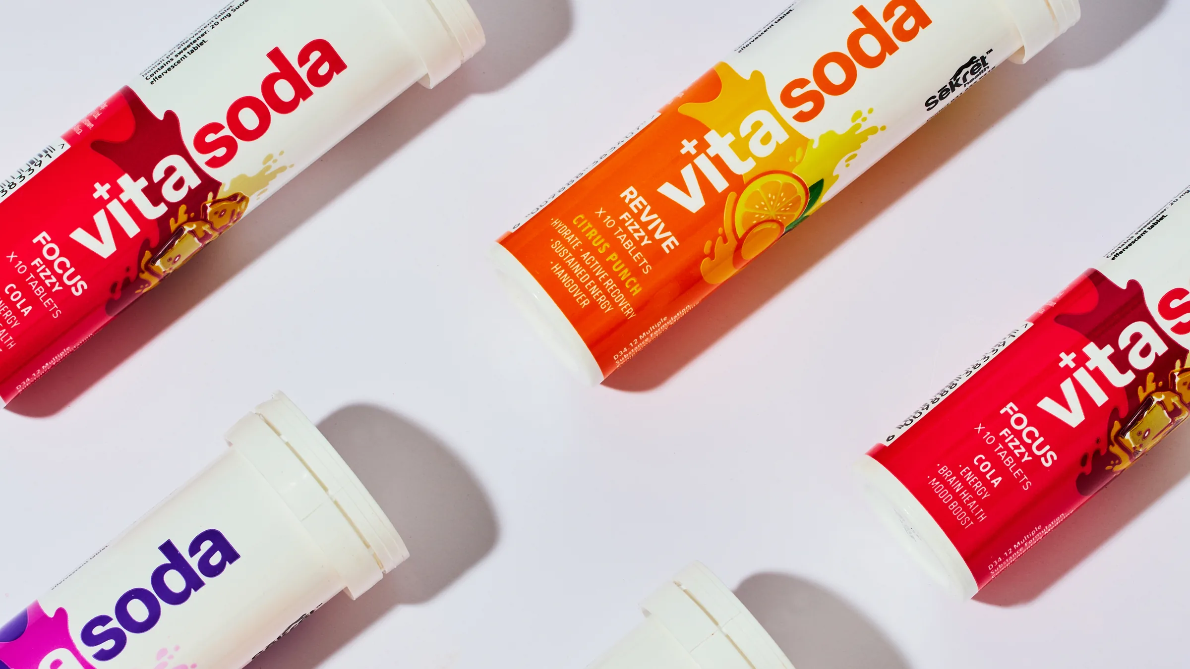 Vita Soda Focus, Glow and Revive tubes laid in a diagonal pattern on white