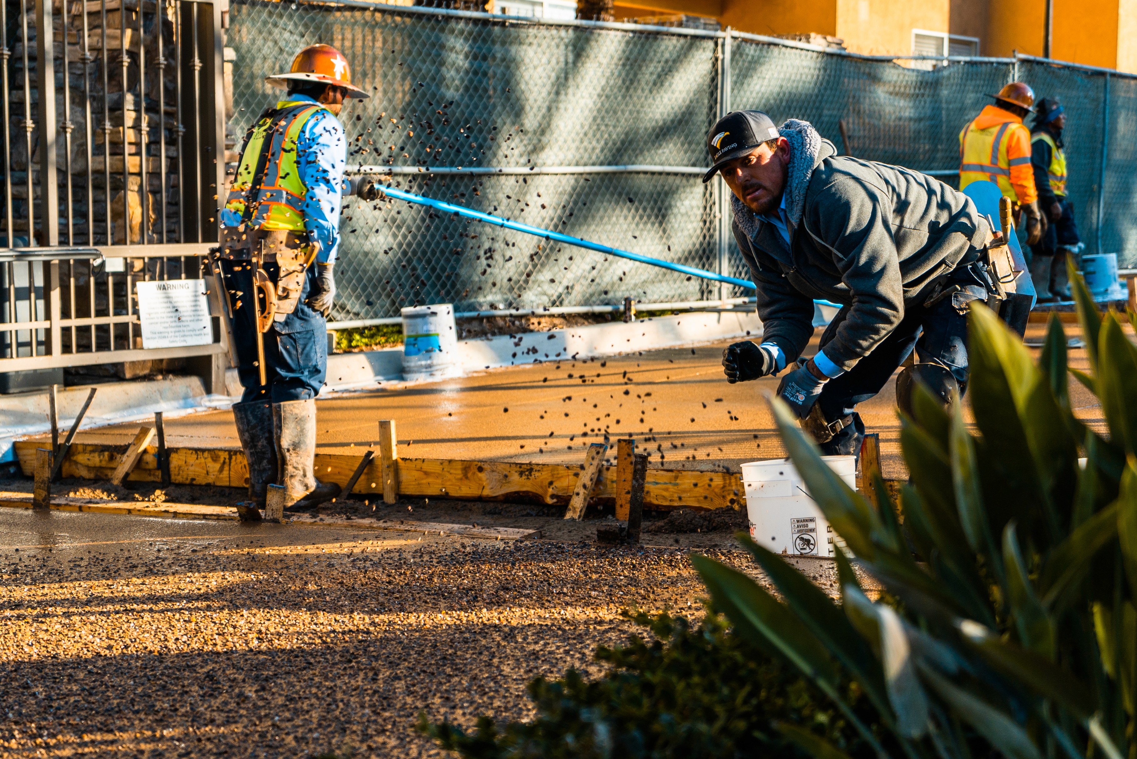 Construction worker applying concrete finish on project