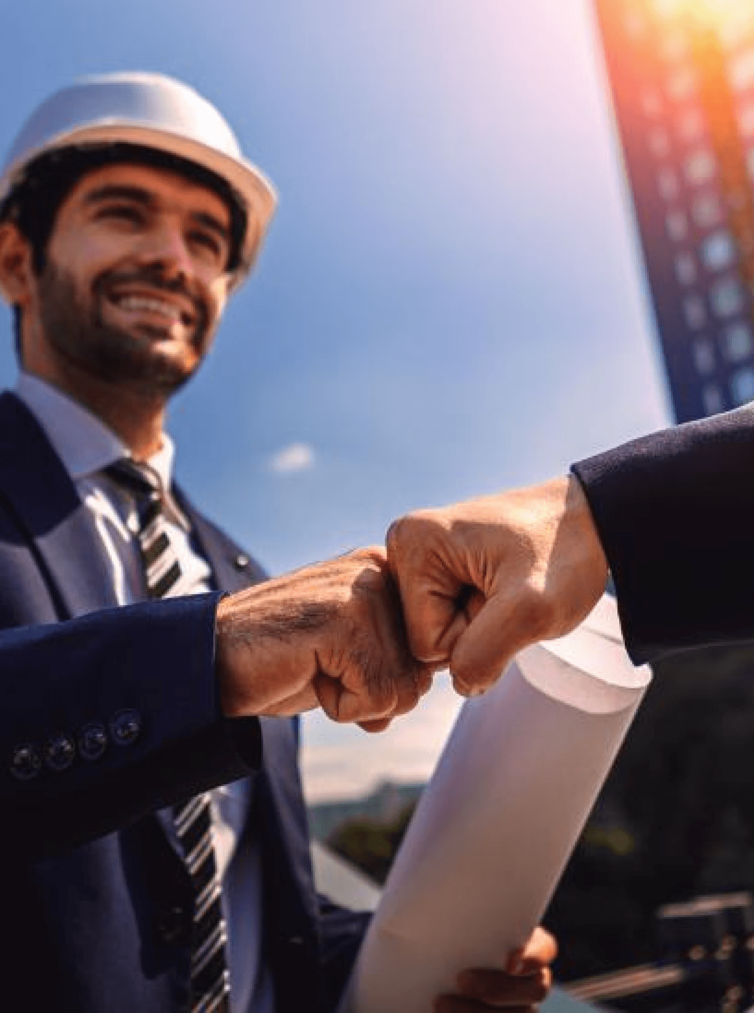 Woman in a beige blazer handing a document to someone, standing near a window with a city view. She looks professional and confident.