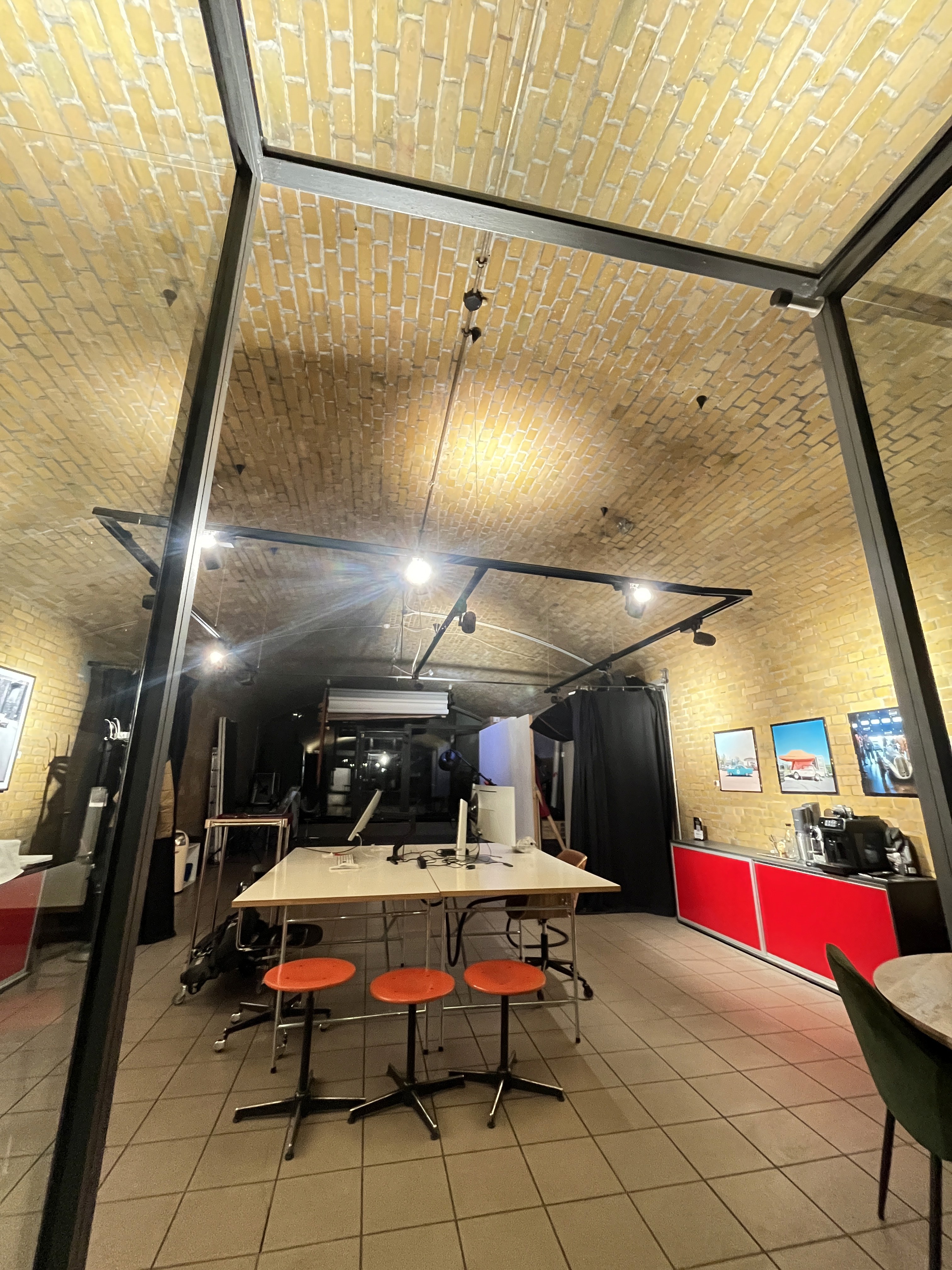 Four diverse professionals collaboratively working on a laptop, with one person pointing at the screen while others observe.