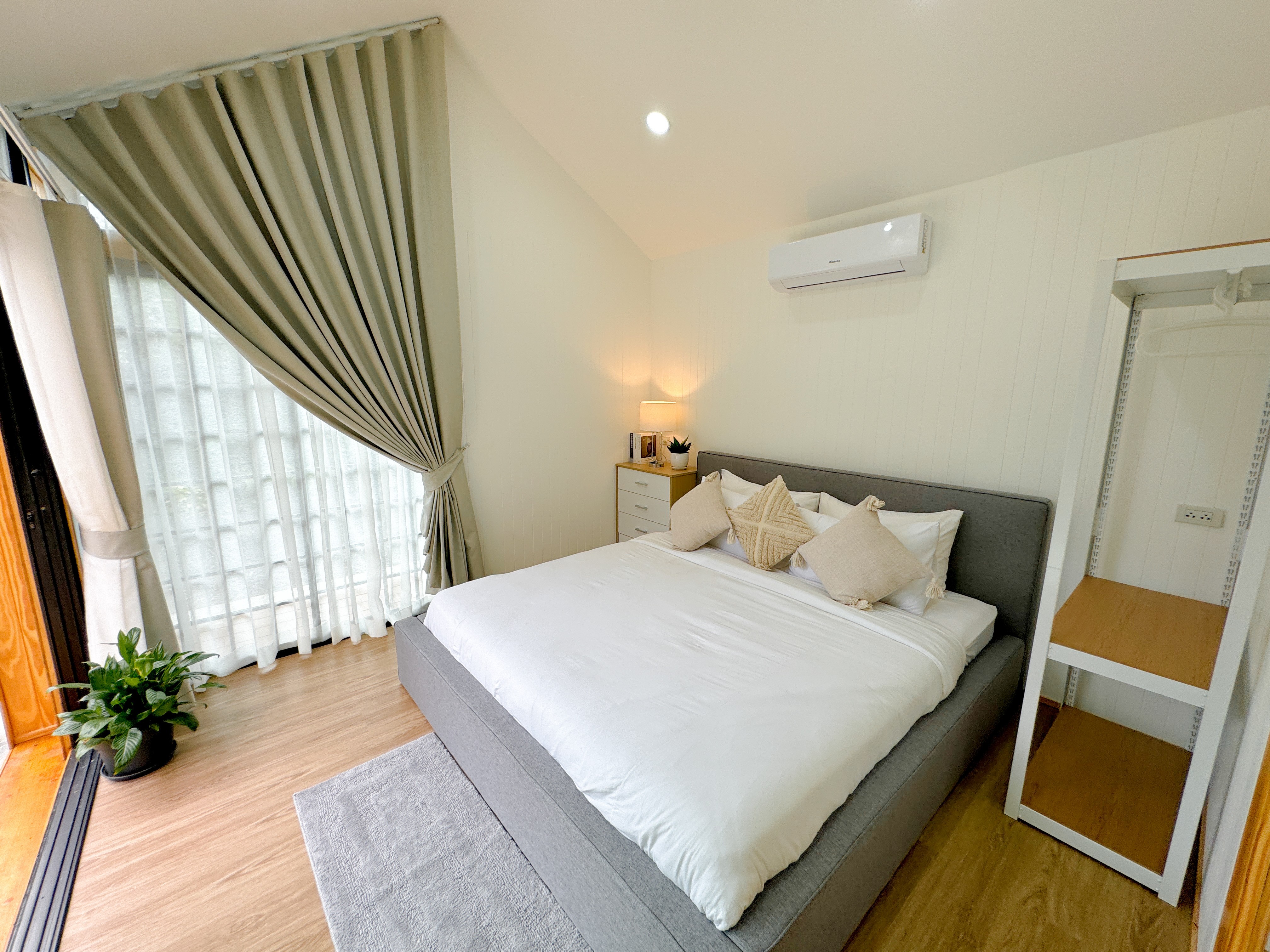 white bed linen with throw pillows