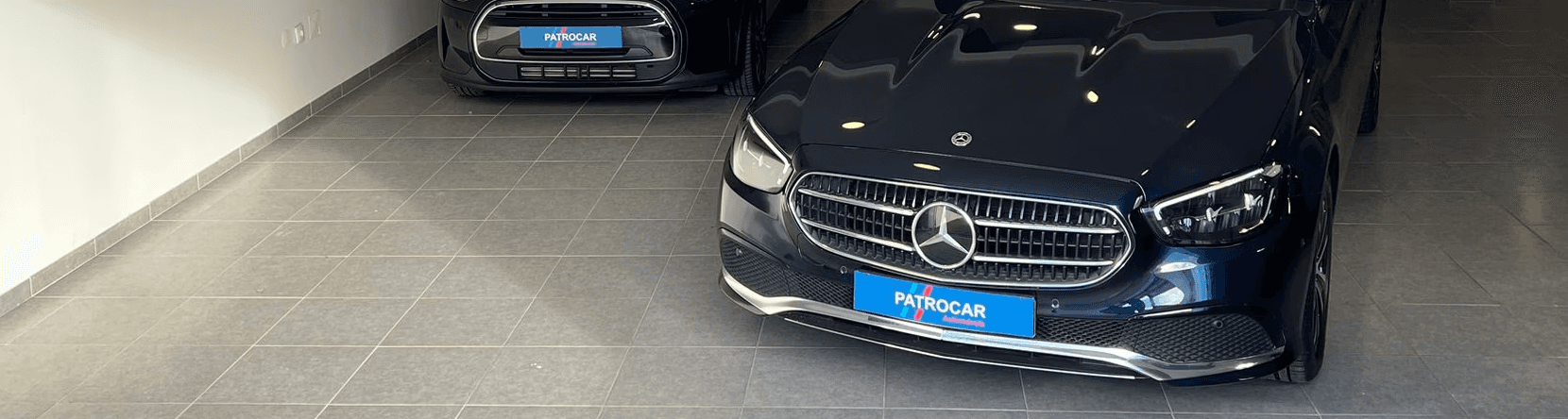 Two cheerful men laughing in the front seats of a sportscar, great for car rental joy promotions.