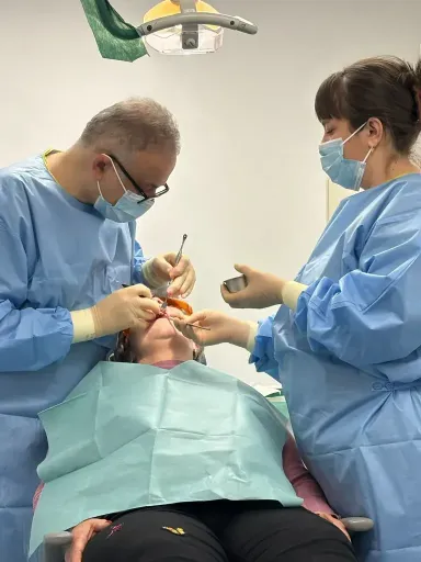 Dr Yasser and his nurse in surgery, to do some dental work on a patient.