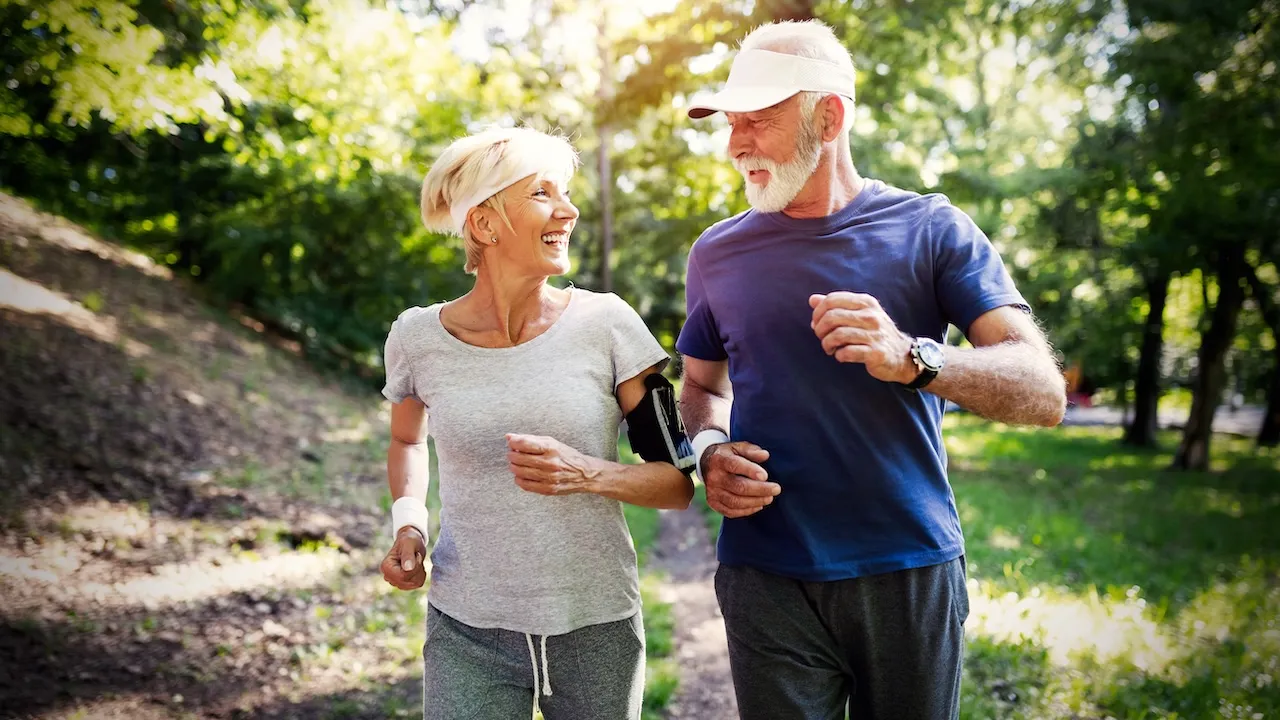 Older couple jogging outside, Parkinson's Disease