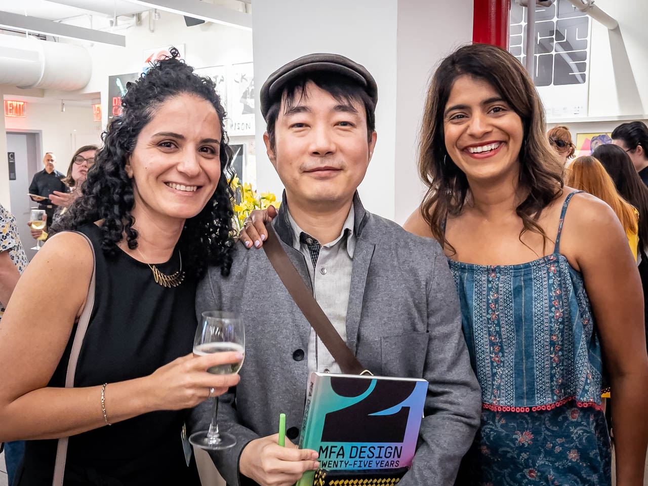 three people at a cocktail party looking at the camera