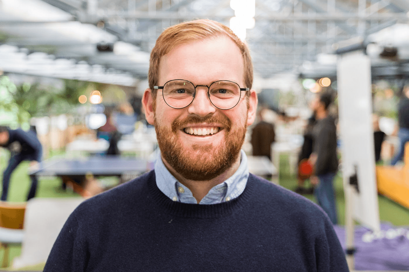 Black and white portrait of a smiling person with curly hair