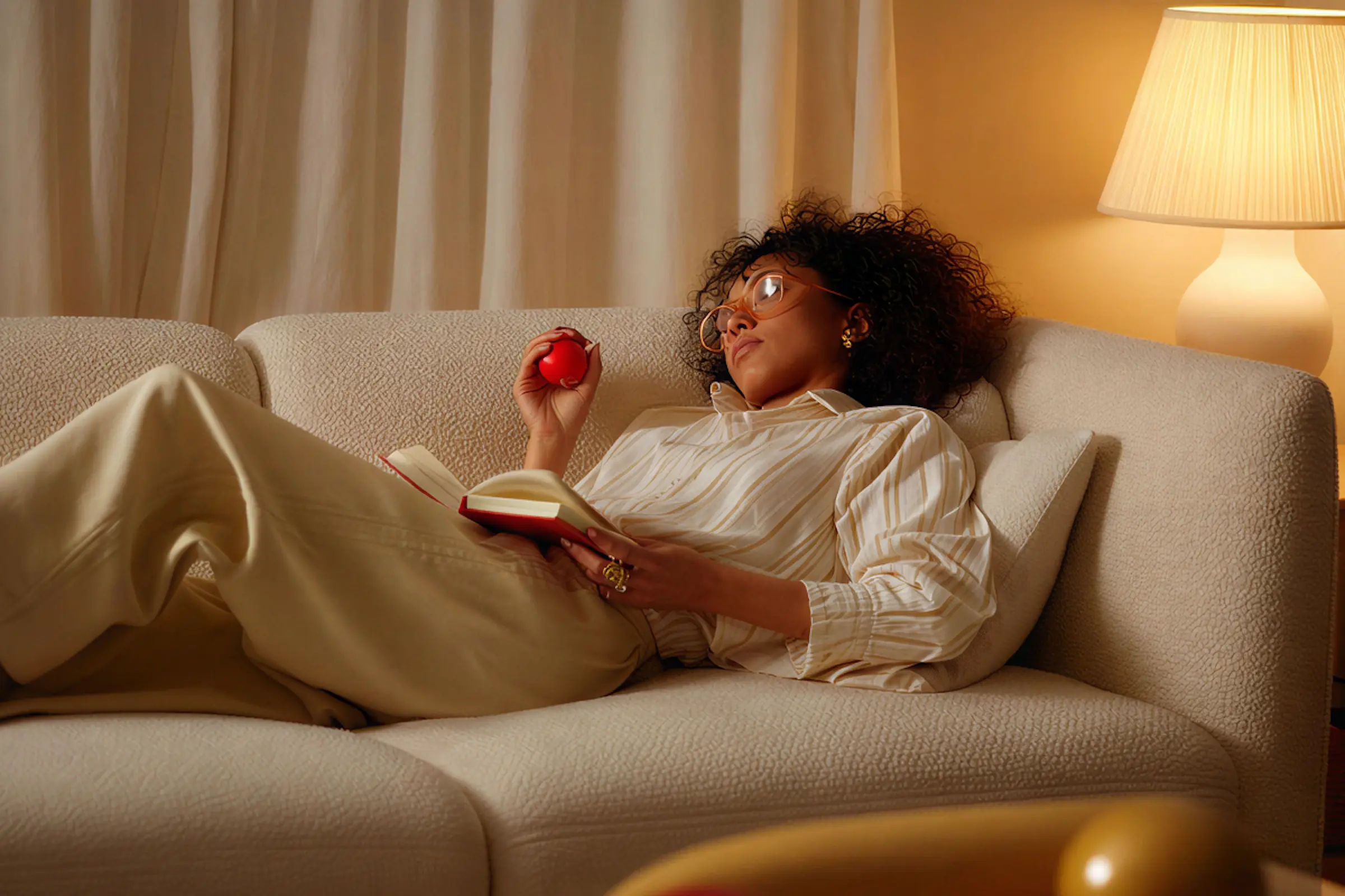 Person relaxing on a couch using a smartphone in a cozy living room