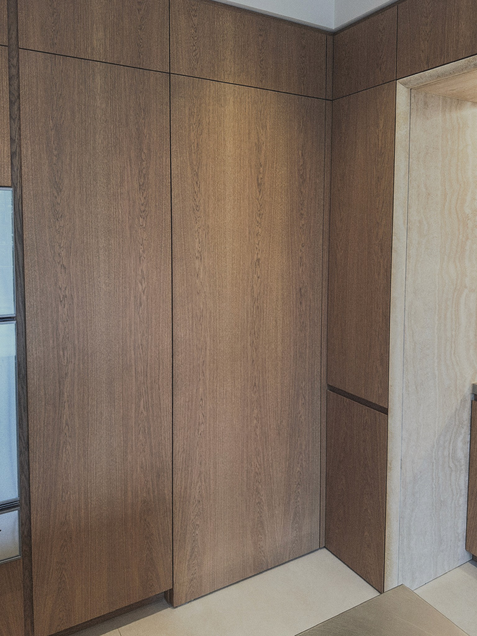 Flush oak wall panelling with concealed doorway detail