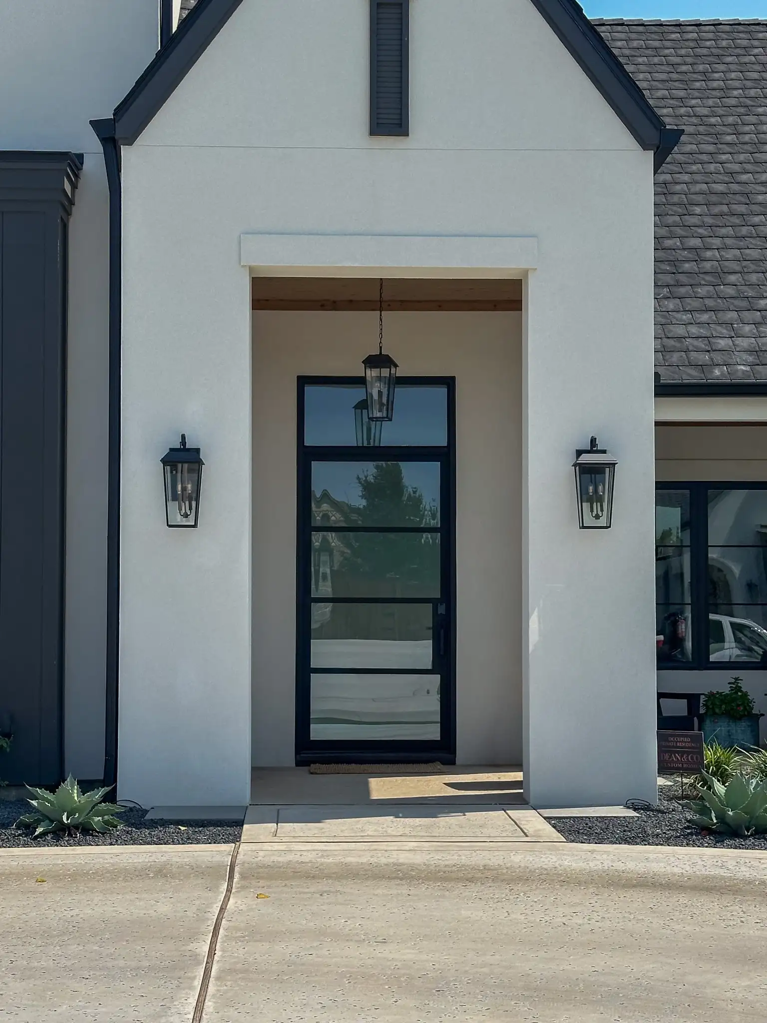 low profile single iron door with transom installed on a DFW new home by M2 Metals
