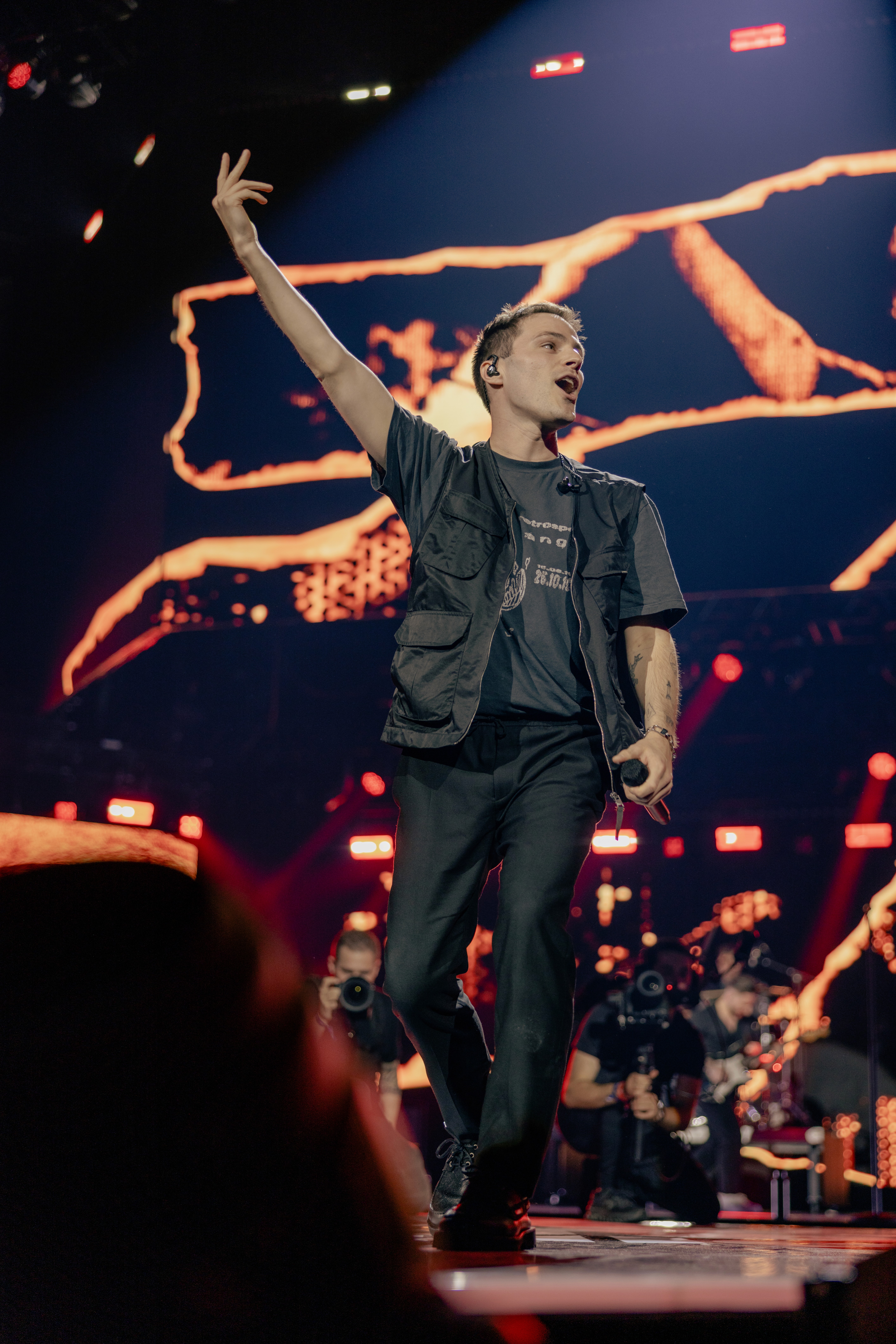 Flat lay of makeup essentials: brush, foundation, and powder on a beige background