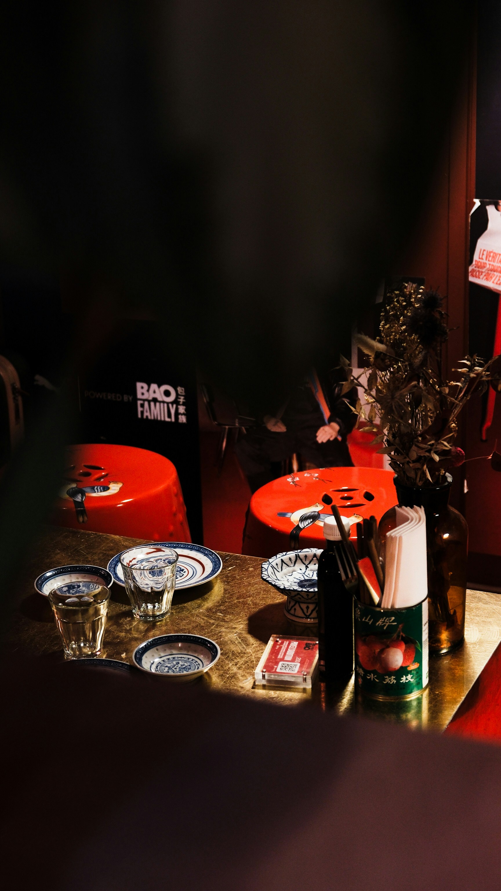 A room with a red carpet and a table with plates on it