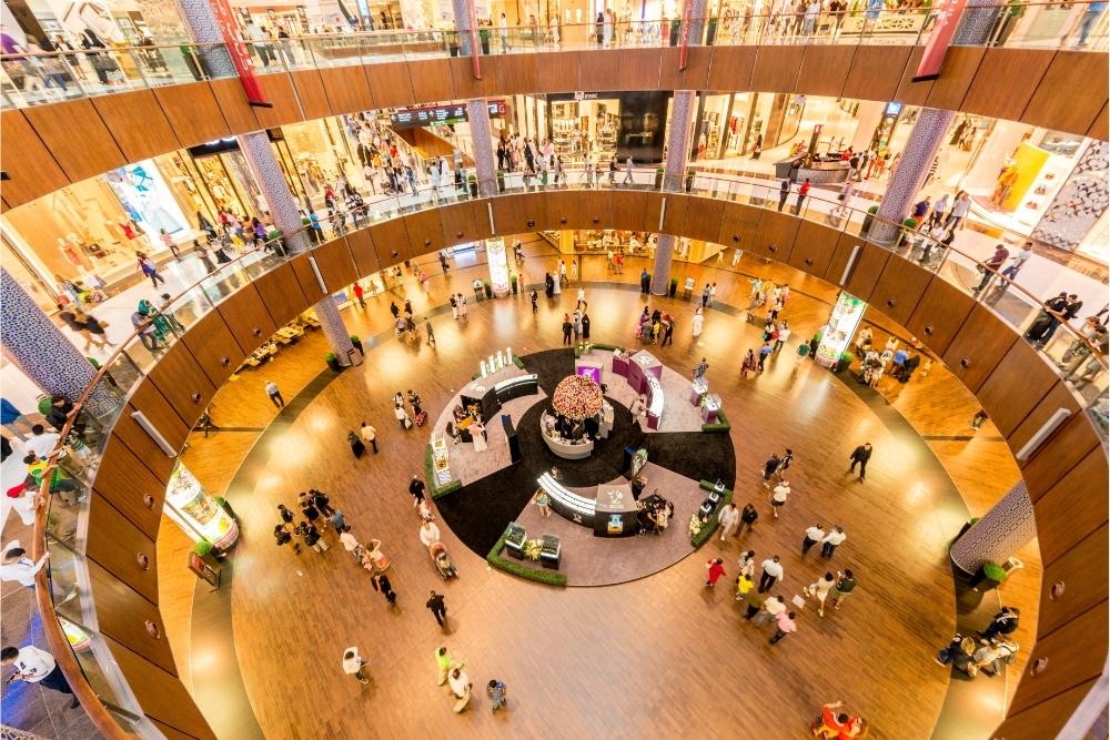 Crowded multi-level shopping mall interior.