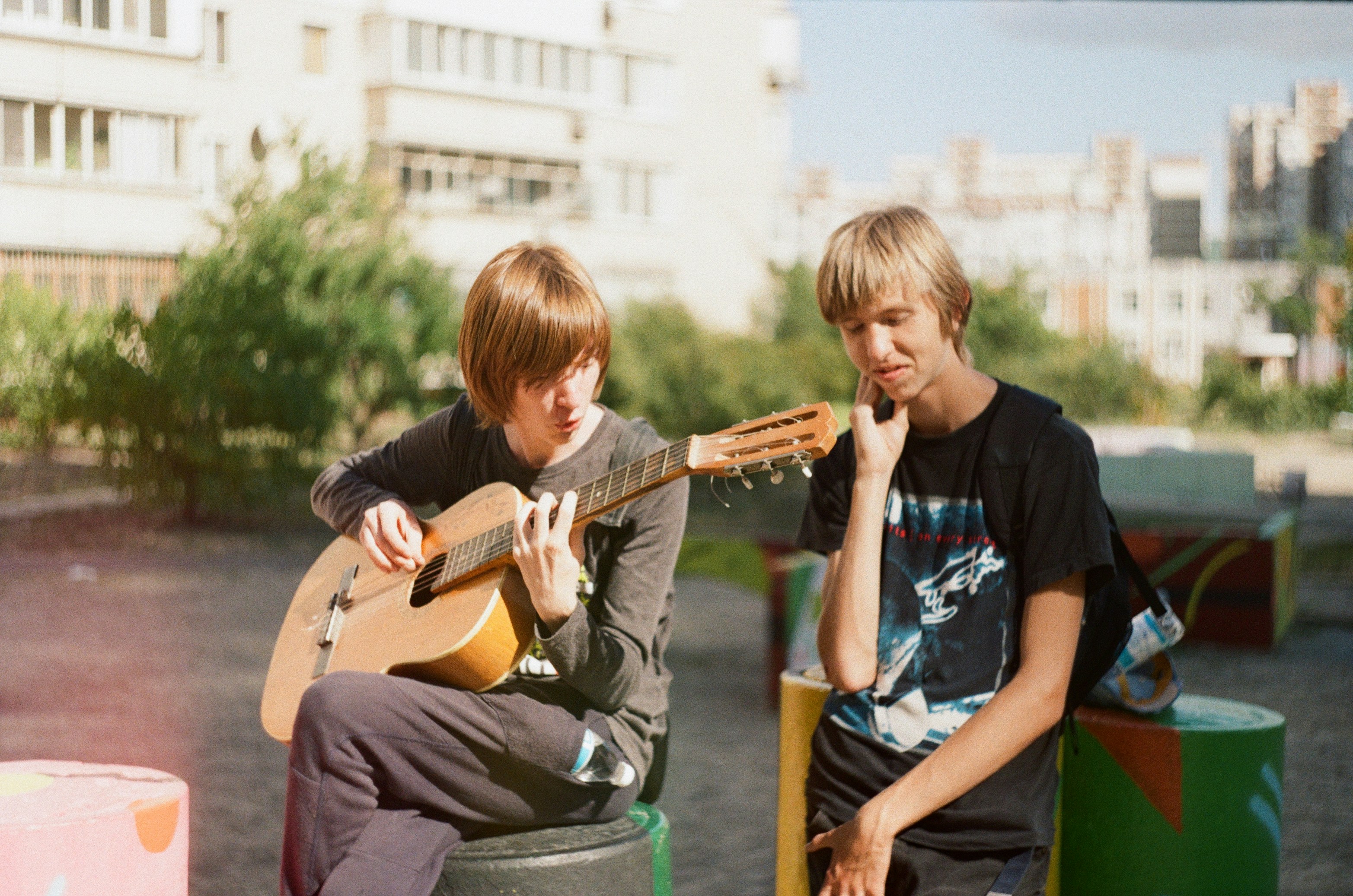 a couple of young men sitting next to each other