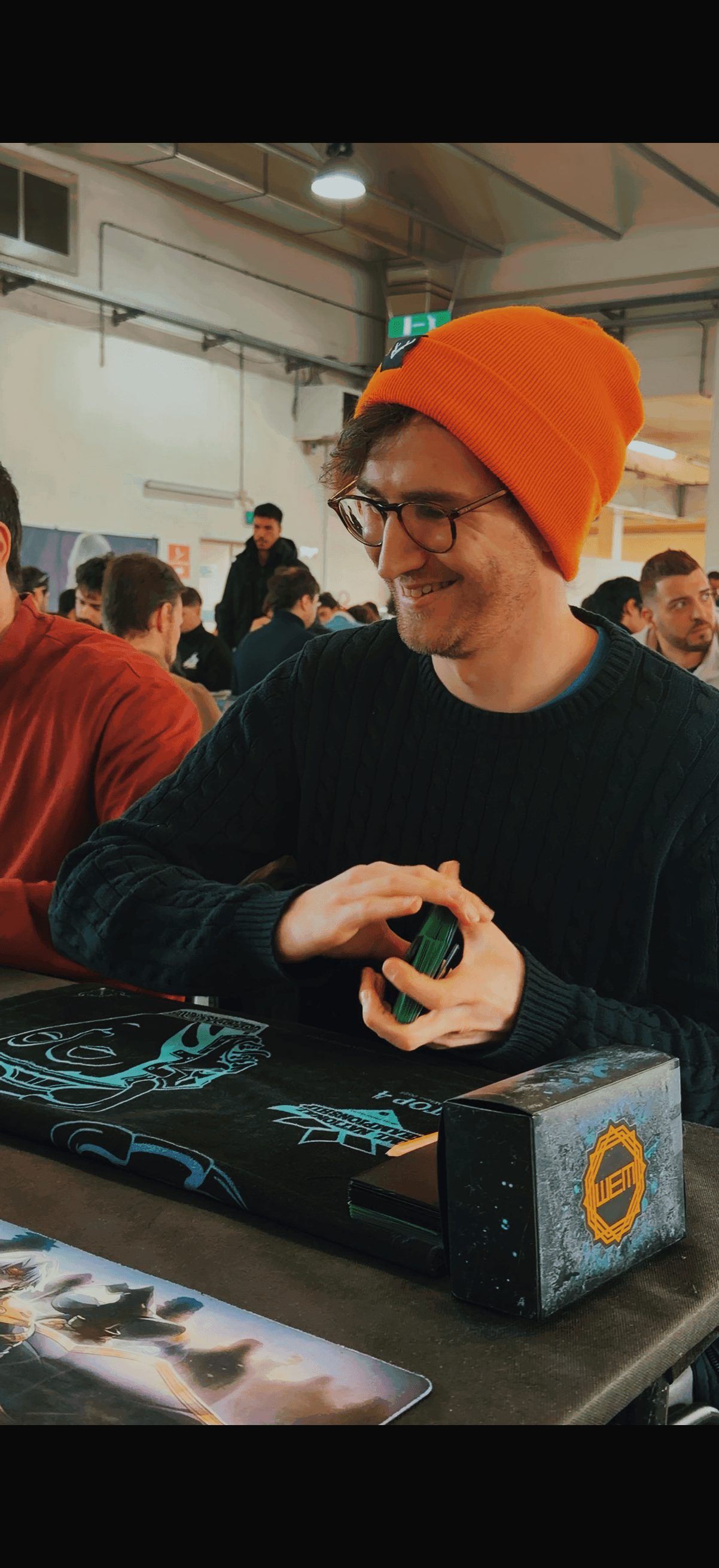 woman holding a phone and man looking at the phone. both are smiling