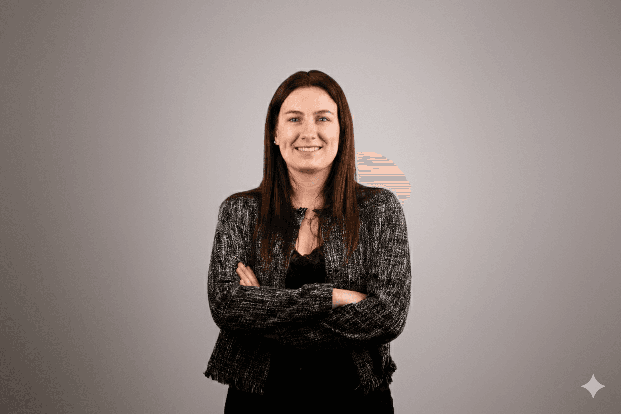 Portrait of a laughing person with curly hair wearing a white shirt