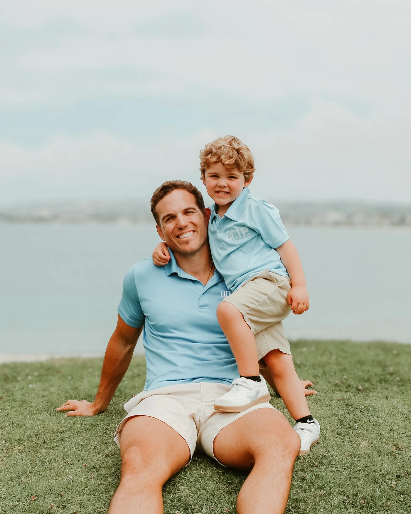 Tyler Watkins with his son Tyler Watkins with his son, both wearing light blue OCIP shirts.