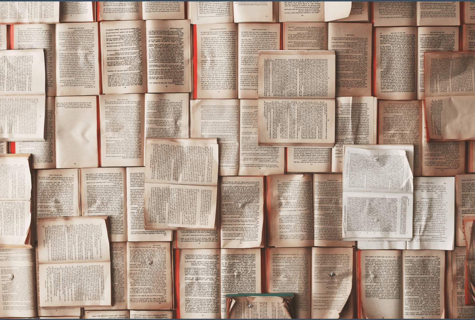 A cozy workspace featuring a wooden desk, a lamp, books, and a plant, illuminated by warm sunlight.