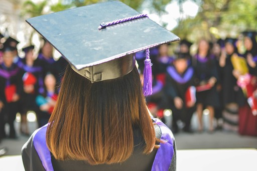 woman wearing academic cap and dress selective focus photography illustrating the degree recognition