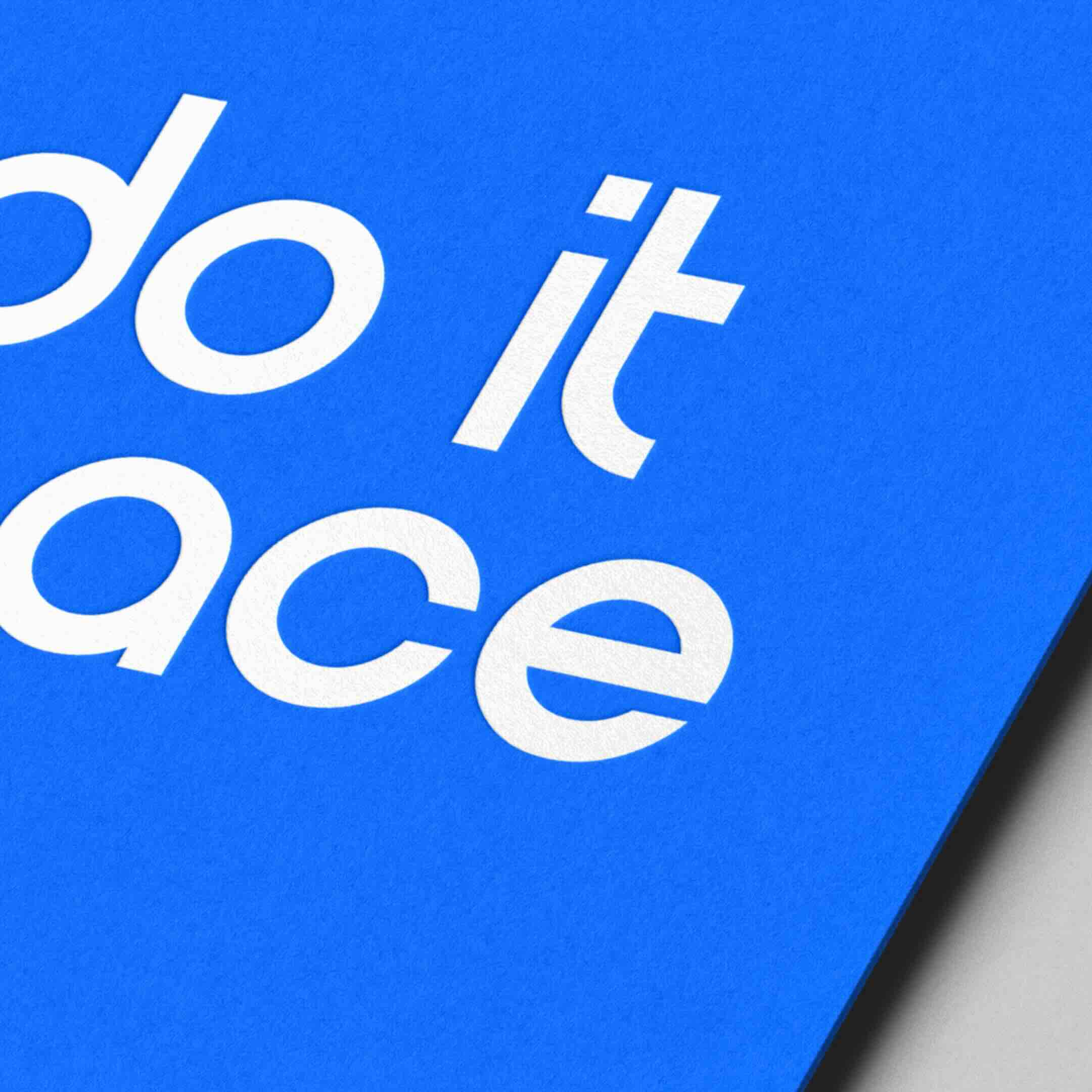 Gloved hand holding a cream card with a logo, wearing a gold bracelet and a blue gemstone flower ring against a red background.