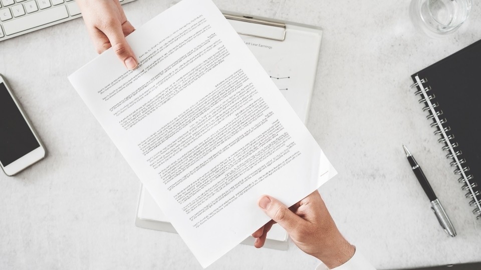 Contract passing hands over a table