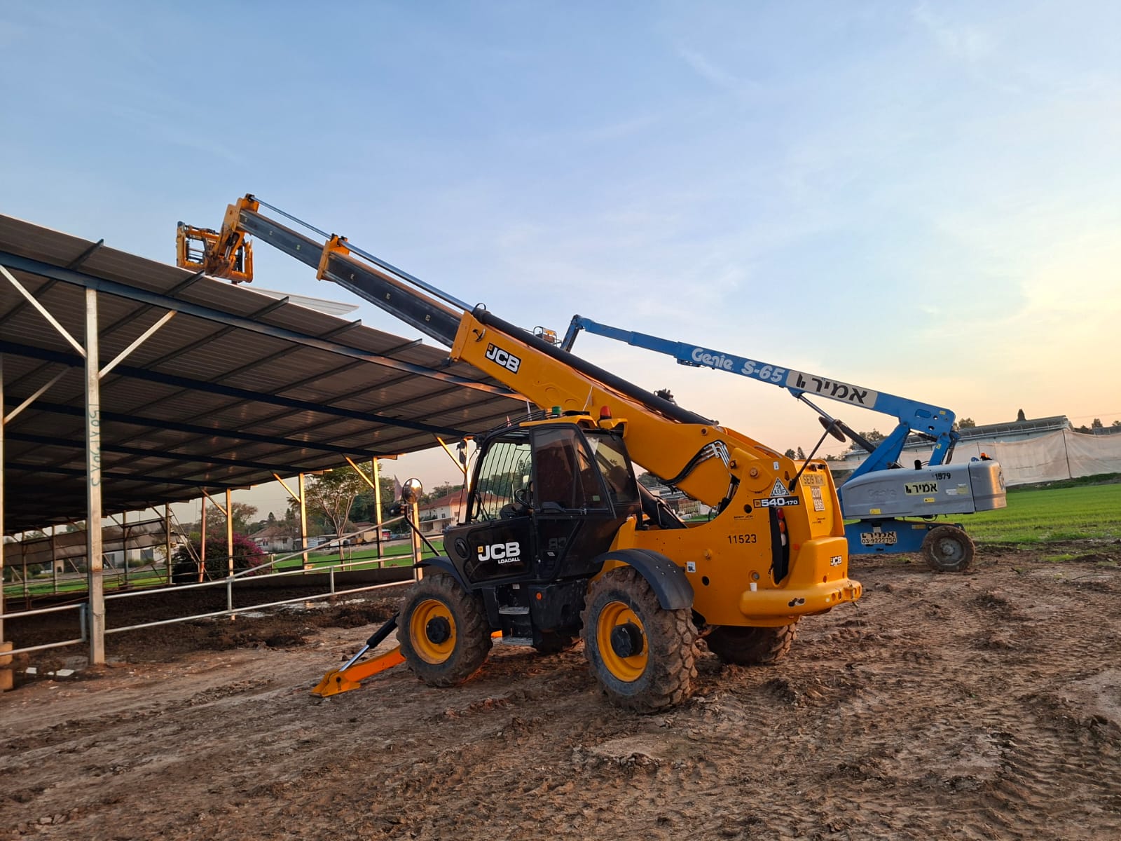 Modern living room with abstract art, beige sectional sofa, indoor plants, and large windows.