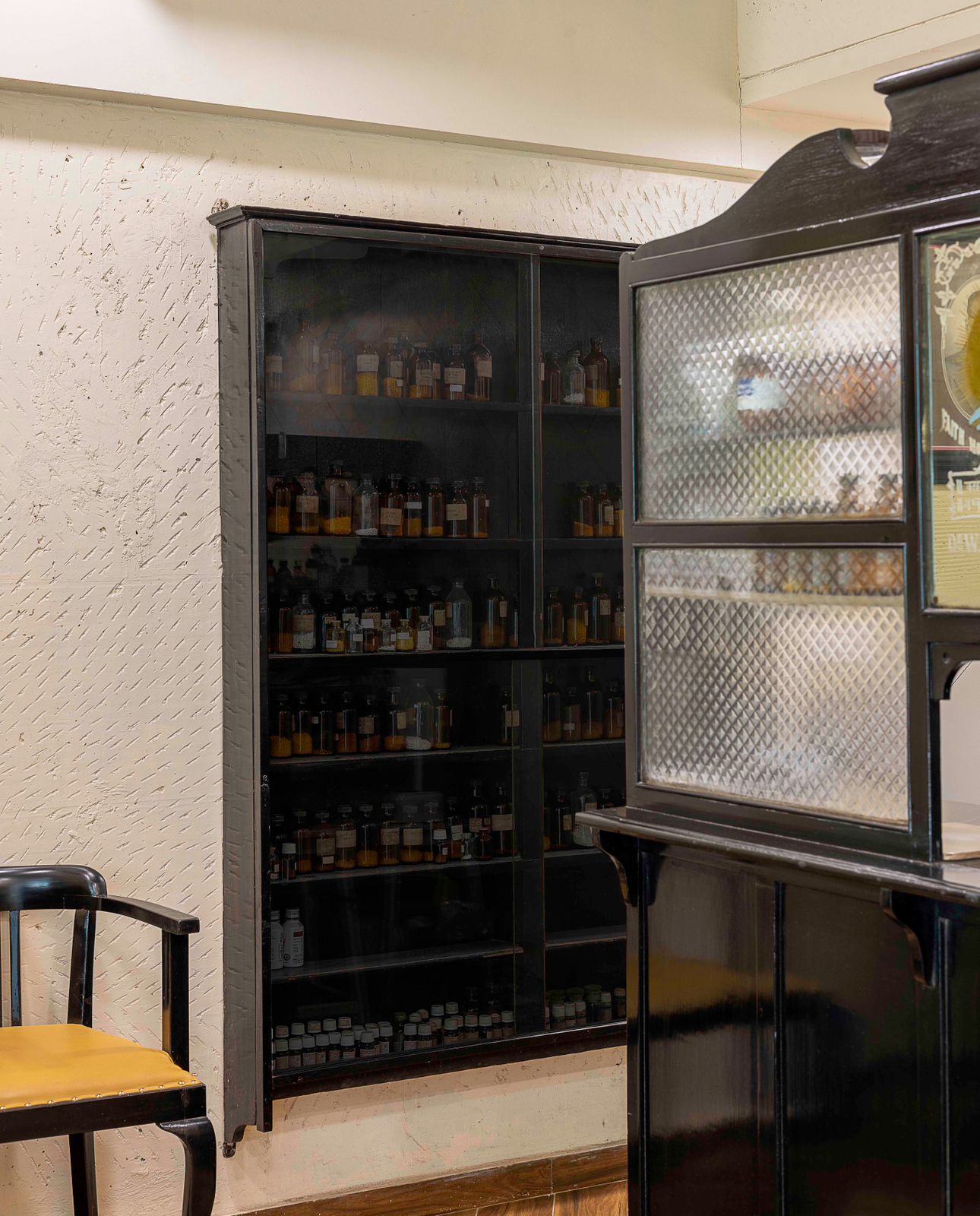 Nature-inspired preschool entrance with sculptural tree partitions and suspended green leaf ceiling panels.