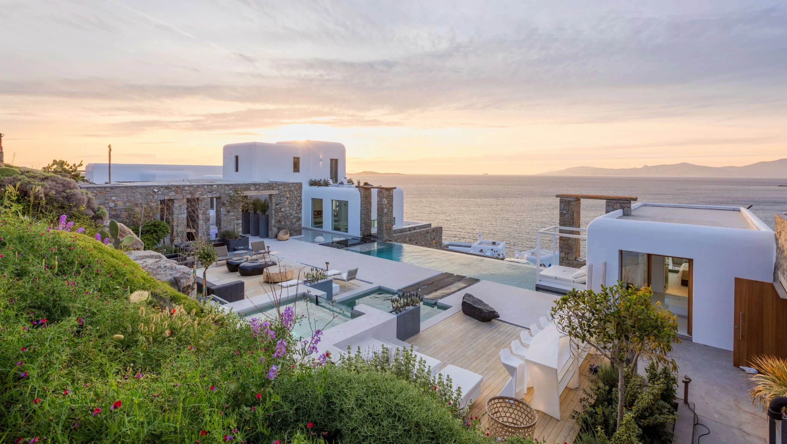 photo of house near cliff and body of water
