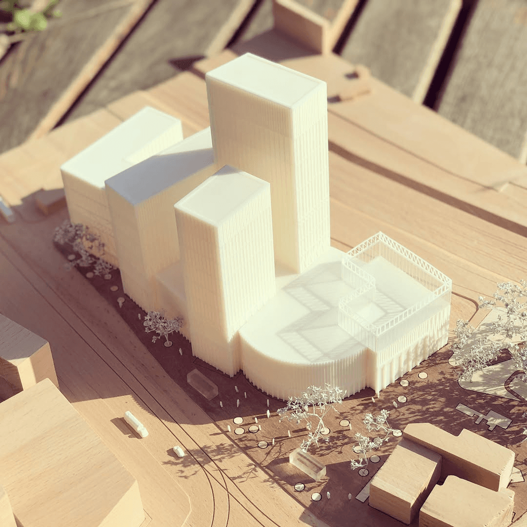 Wooden base with white 3d printed building shoot taken from top