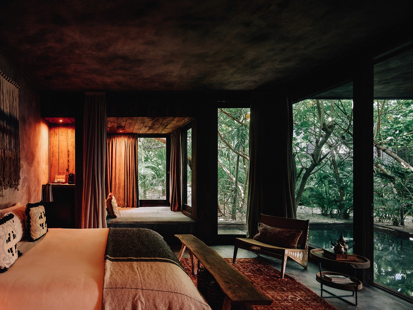 Fuego Suite at Nômade Tulum featuring private pool, seating area with chairs and table, and hanging lamps.