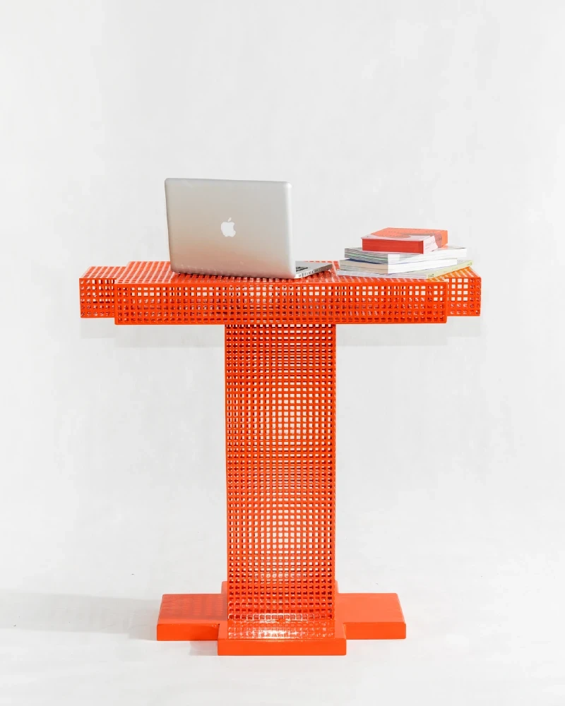 Orange metropolis console with macbook on it