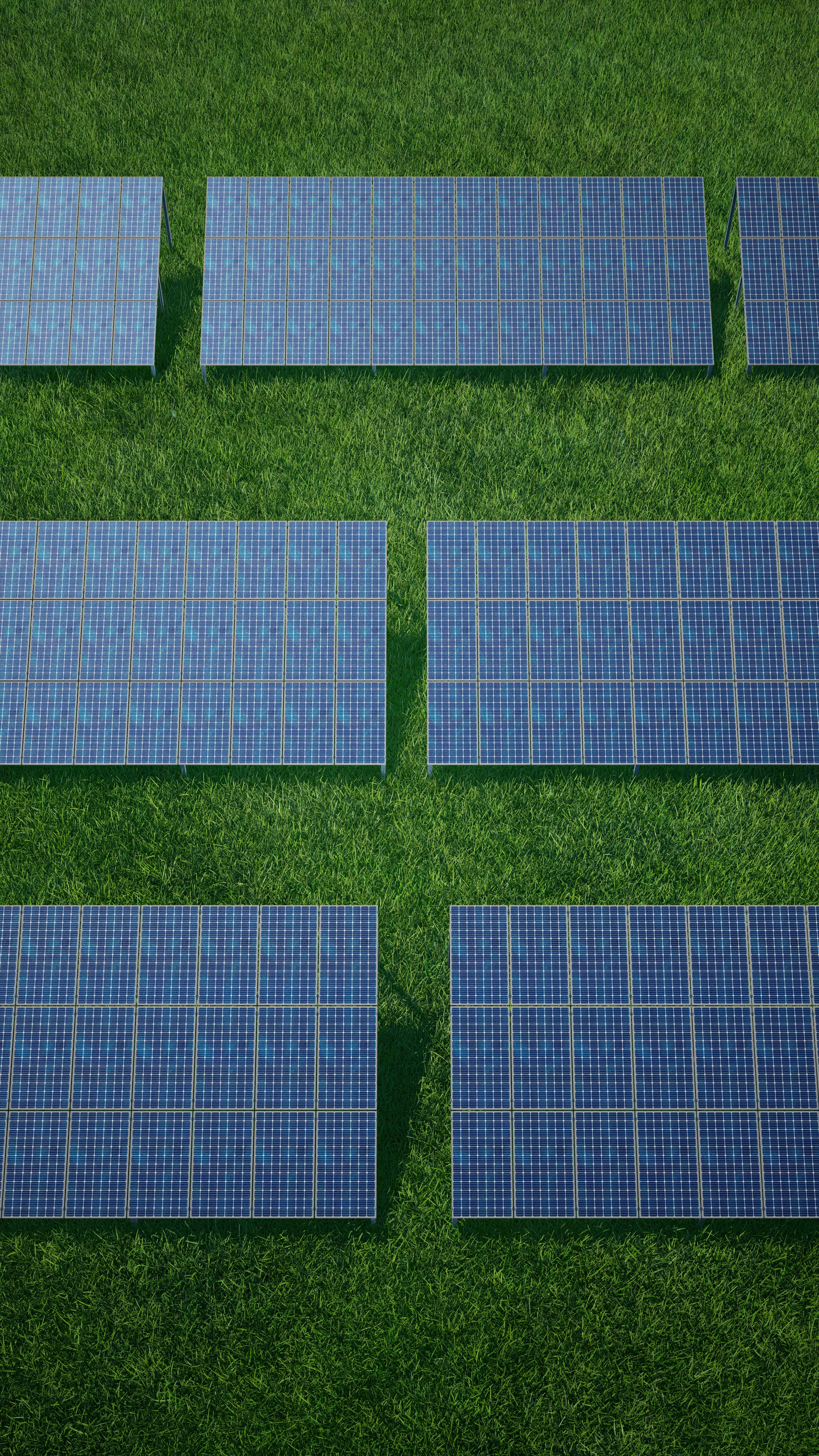Solar panels array in a green field under blue sky